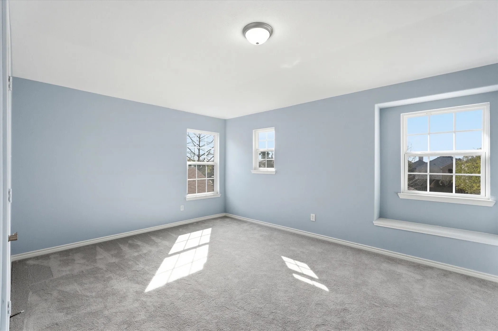 Empty room featuring light colored carpet