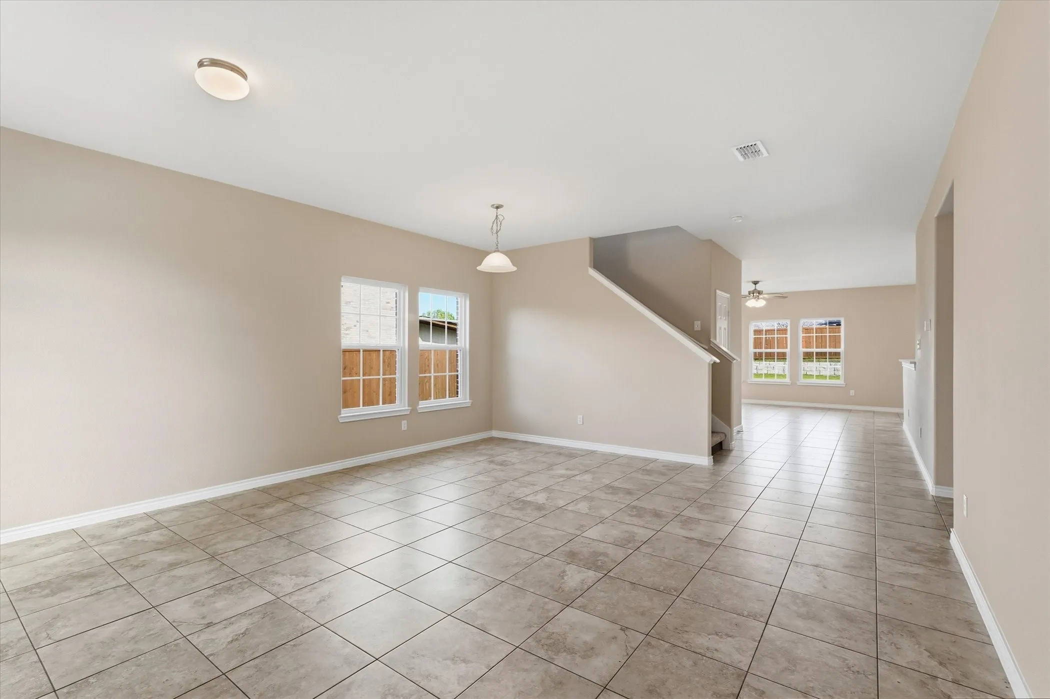 Spare room featuring light tile patterned floors and a ceiling fan