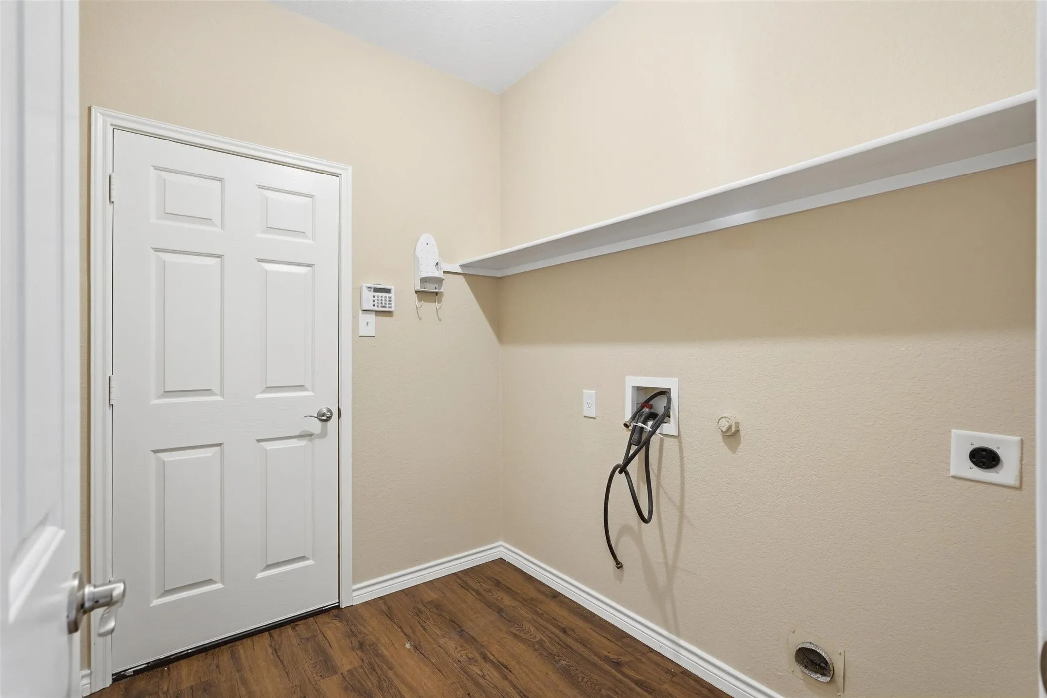 Laundry area featuring gas dryer hookup, washer hookup, dark wood-style floors, and hookup for an electric dryer