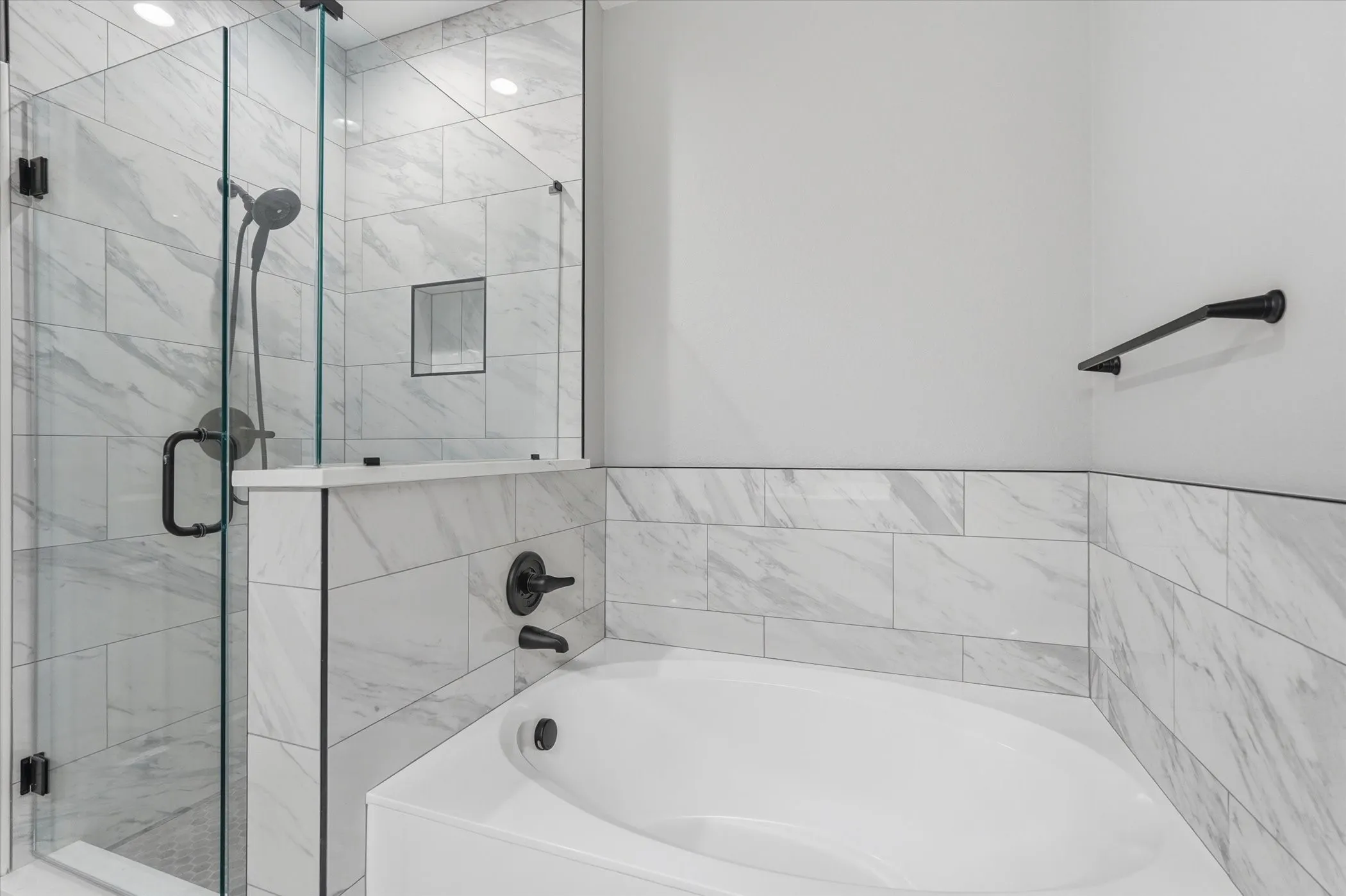 Full bathroom featuring a stall shower and a bath