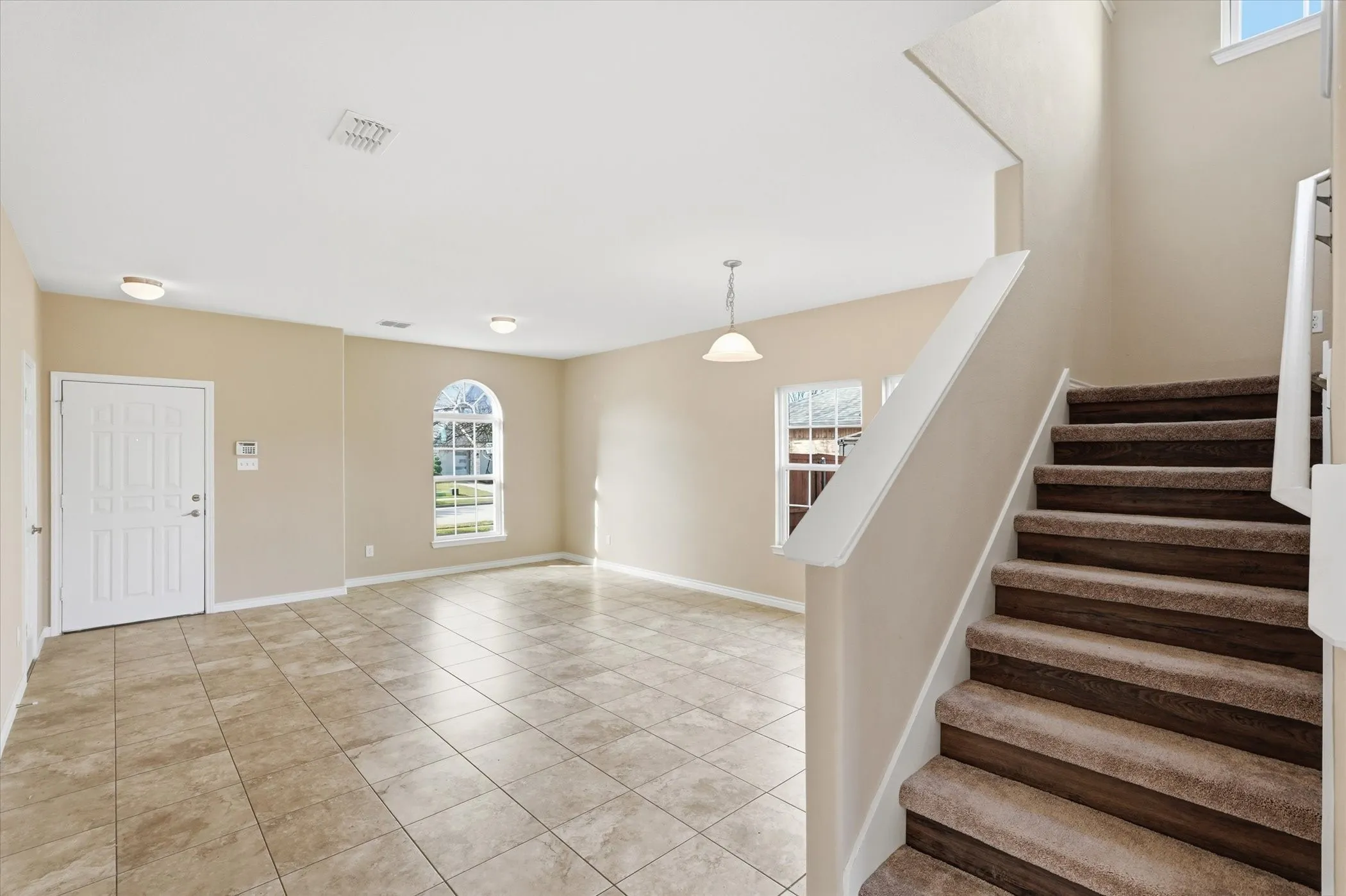 Staircase featuring tile patterned flooring and baseboards