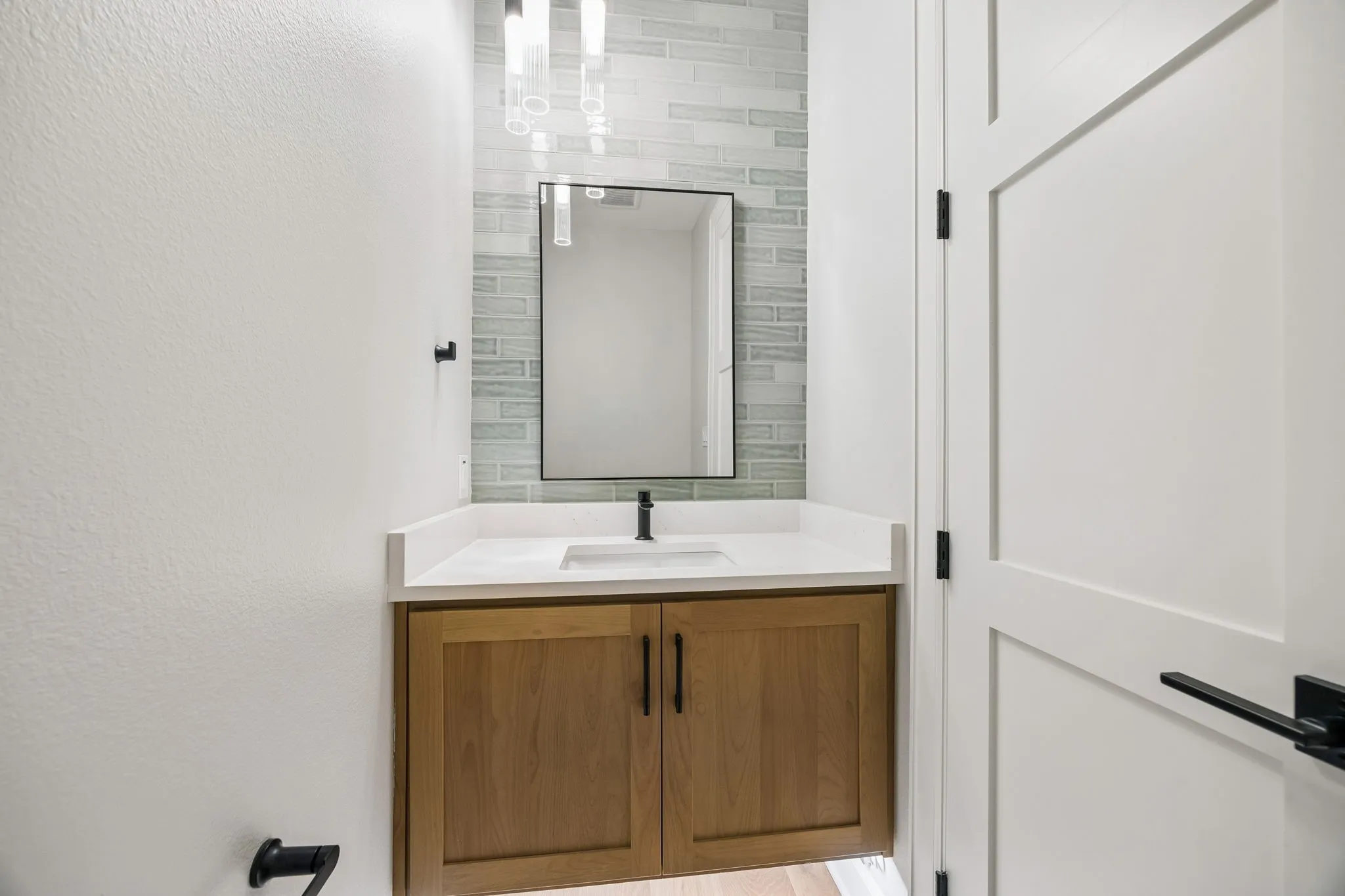 Bathroom with vanity and a textured wall
