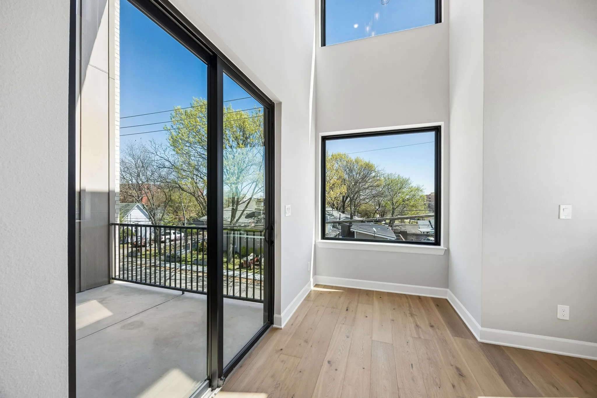 Doorway to outside with hardwood / wood-style floors and a high ceiling