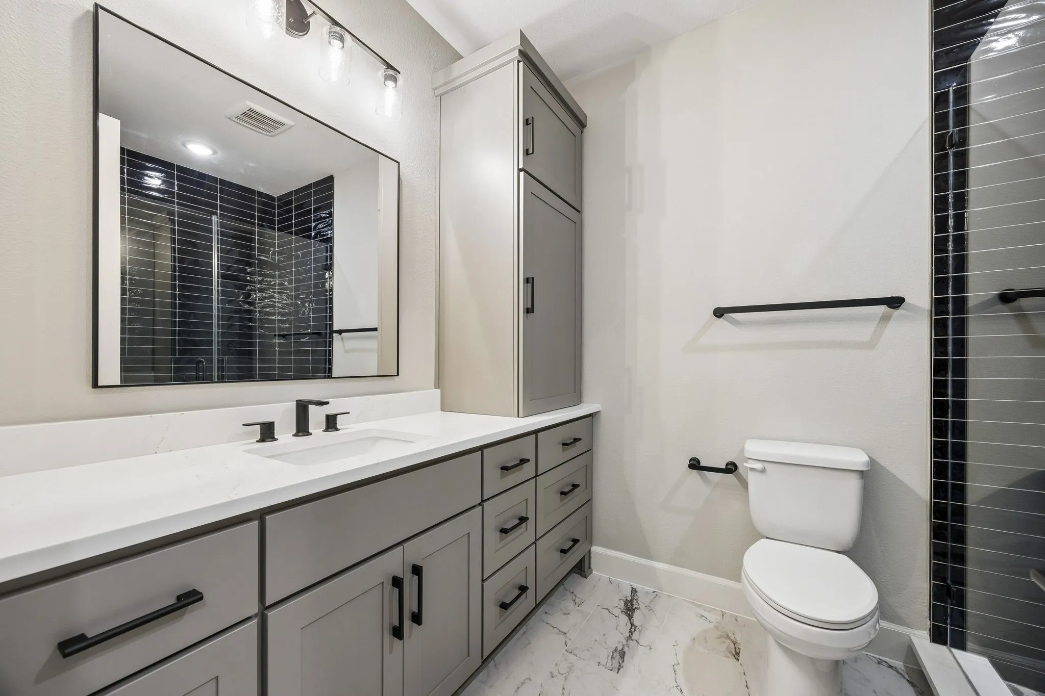 Full bathroom with vanity, a shower stall, and light marble finish flooring