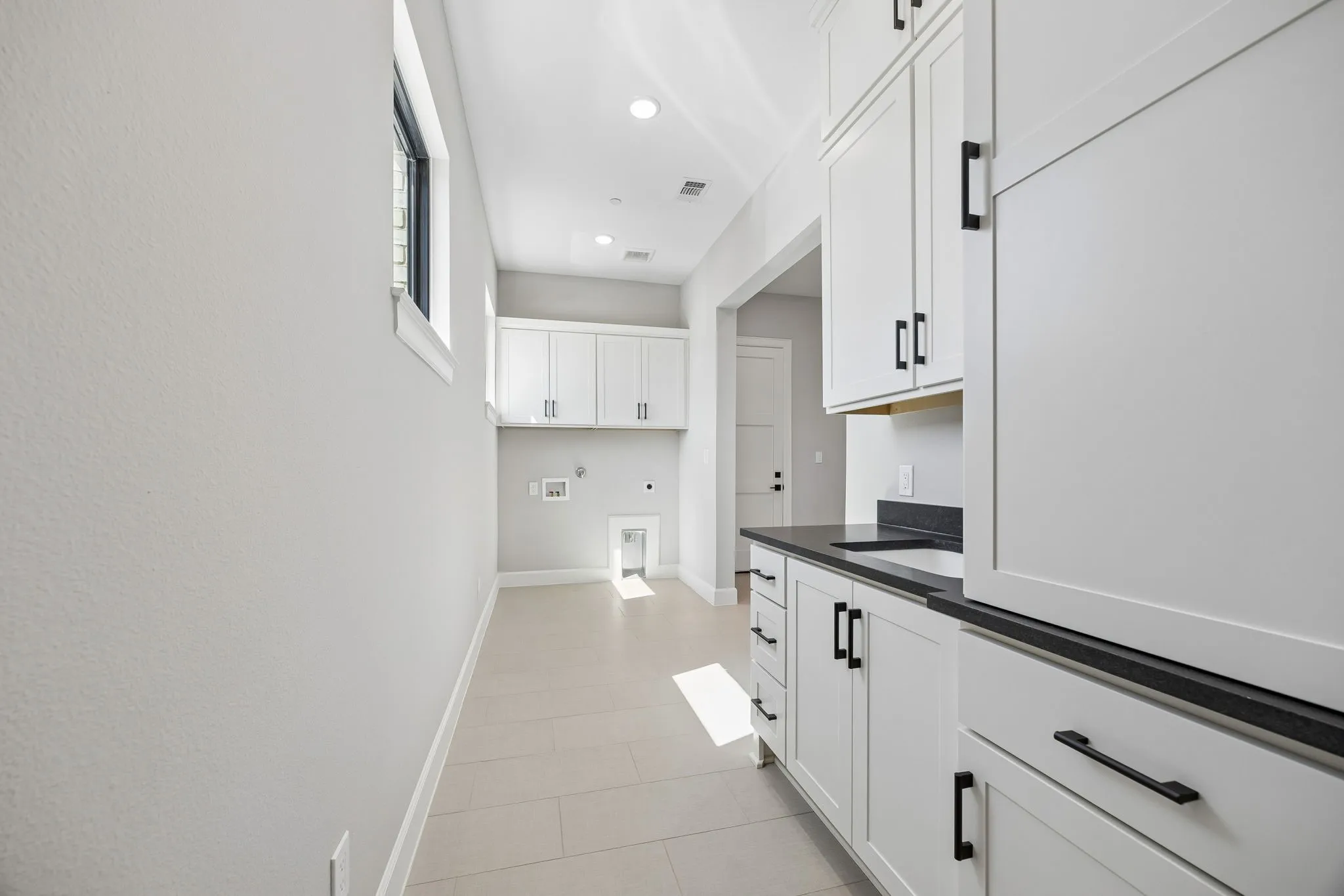 Laundry area with cabinet space, washer hookup, electric dryer hookup, gas dryer hookup, and recessed lighting
