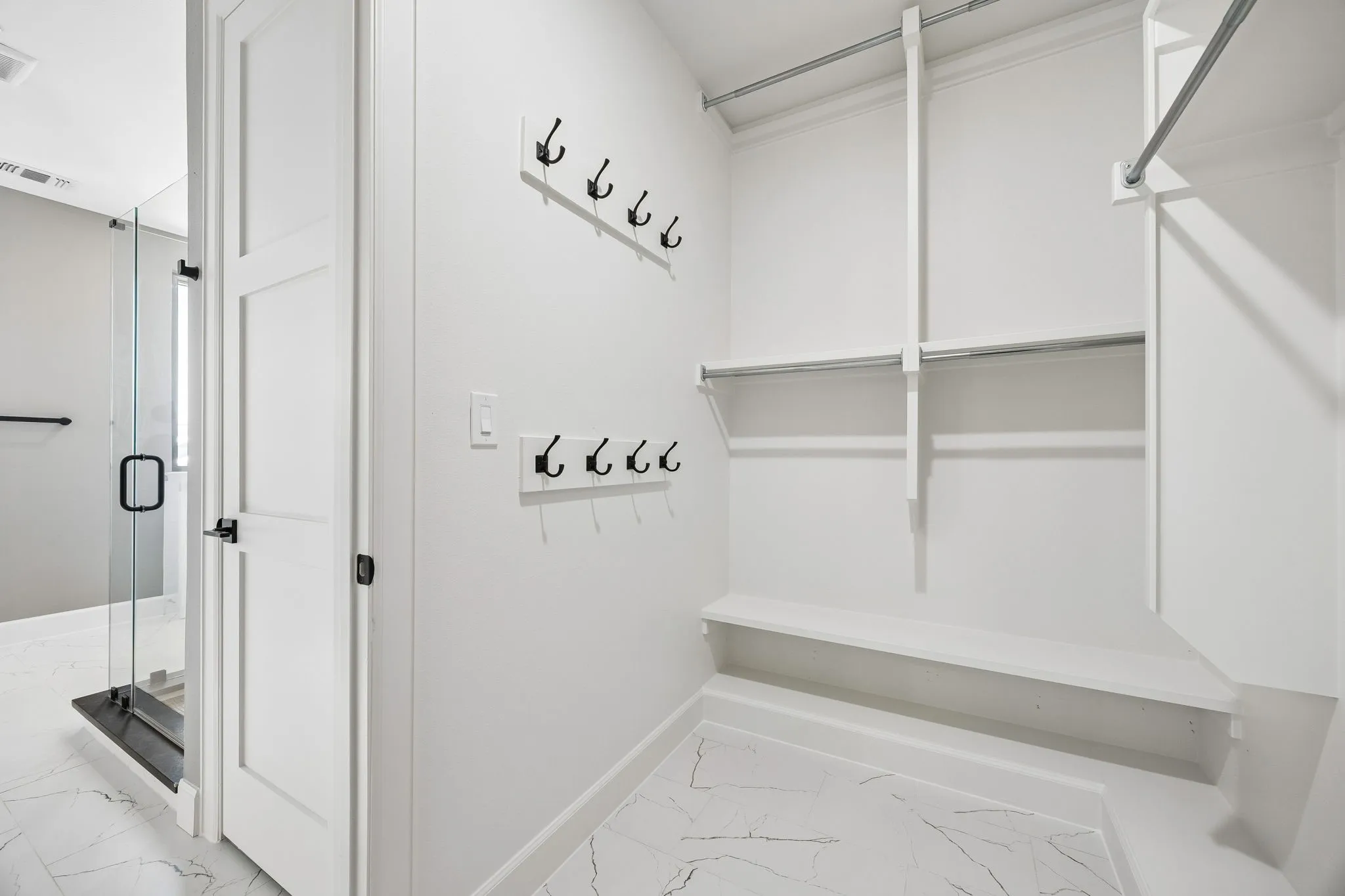 Mudroom with light marble finish floors and baseboards