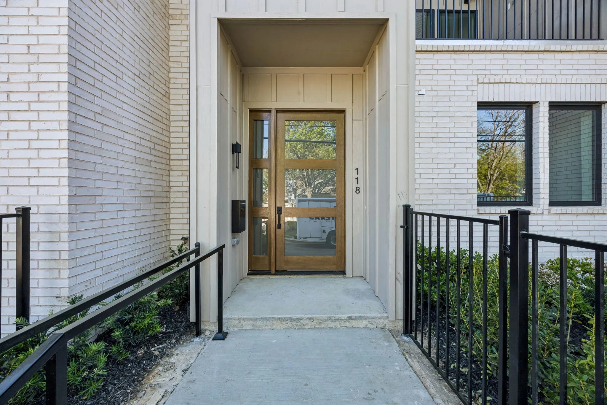 View of exterior entry featuring brick siding and board and batten siding