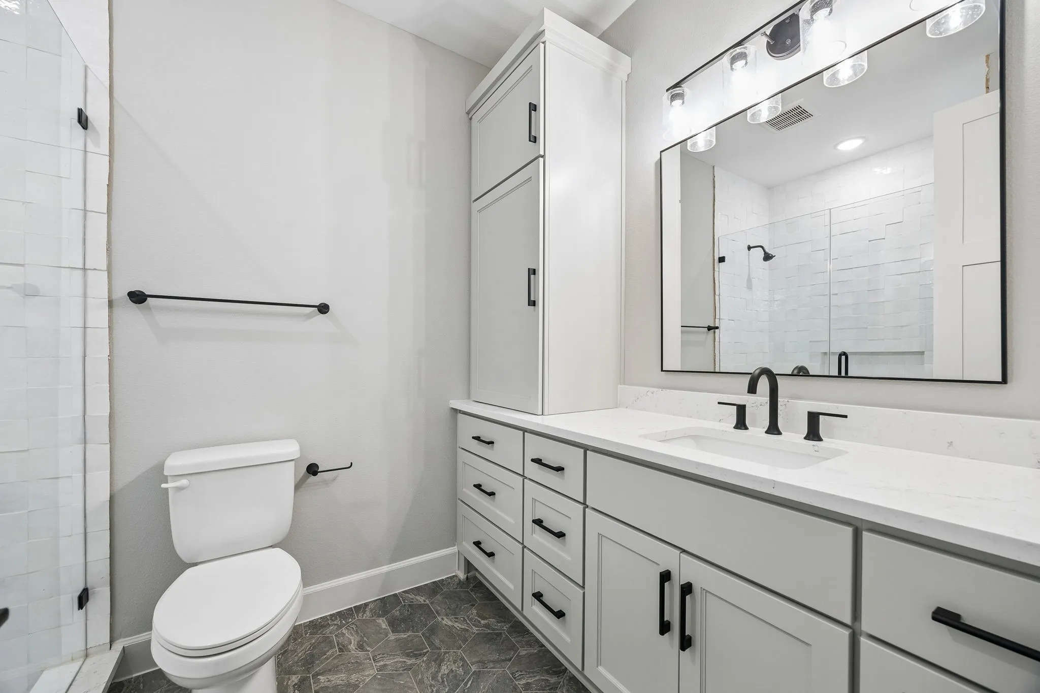 Full bath featuring vanity and a shower stall