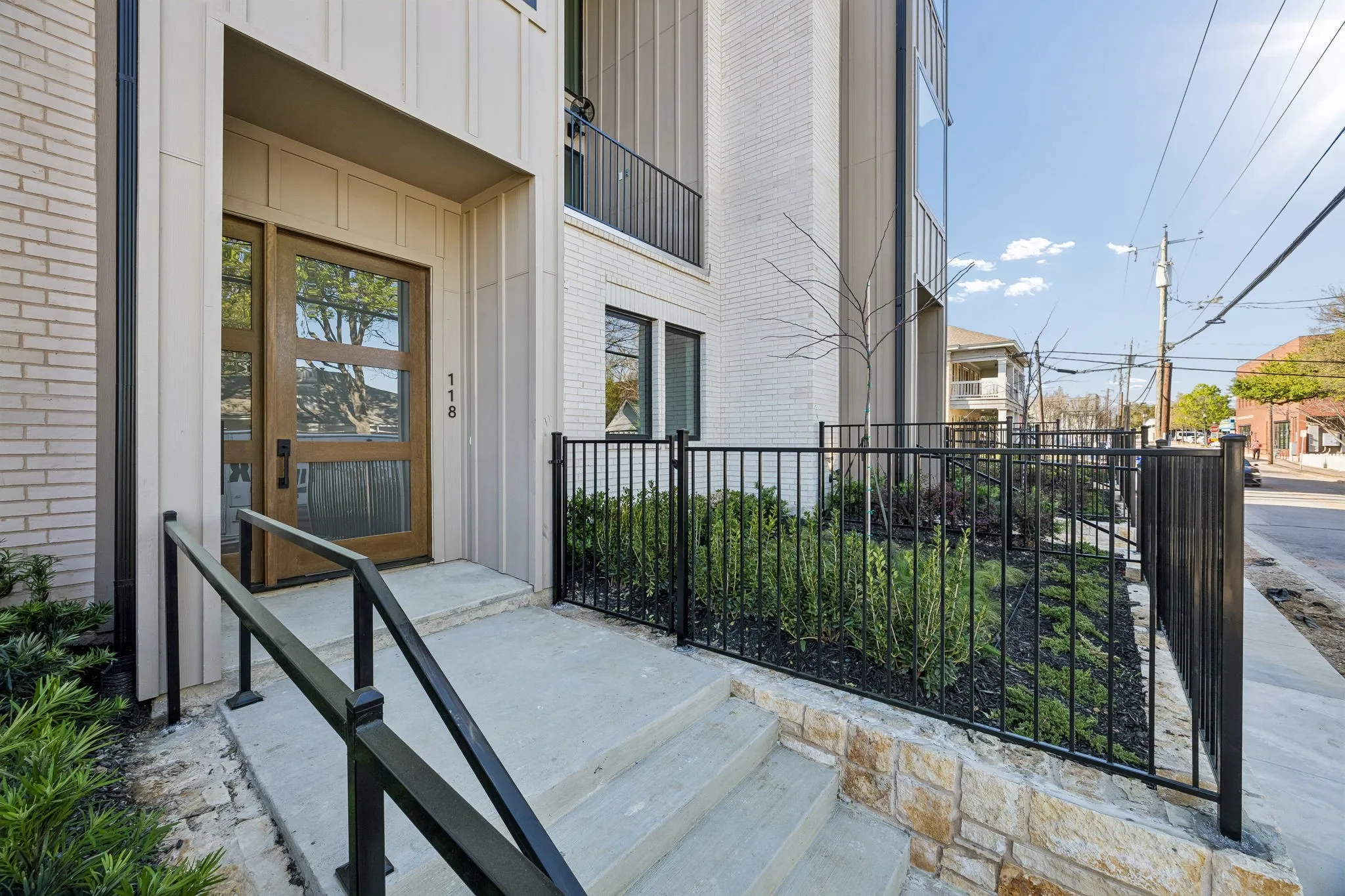 Entrance to property featuring board and batten siding and brick siding