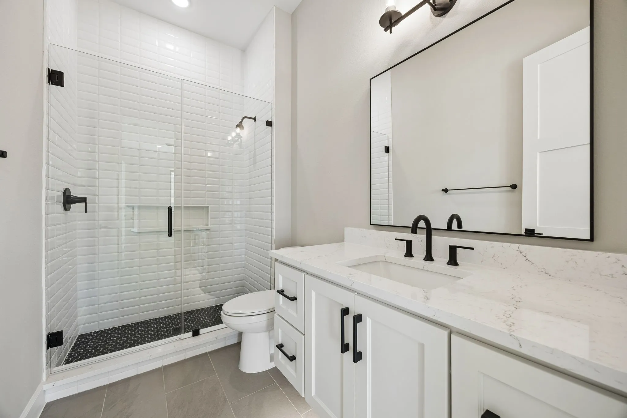 Bathroom with vanity, a stall shower, light tile patterned floors, and recessed lighting