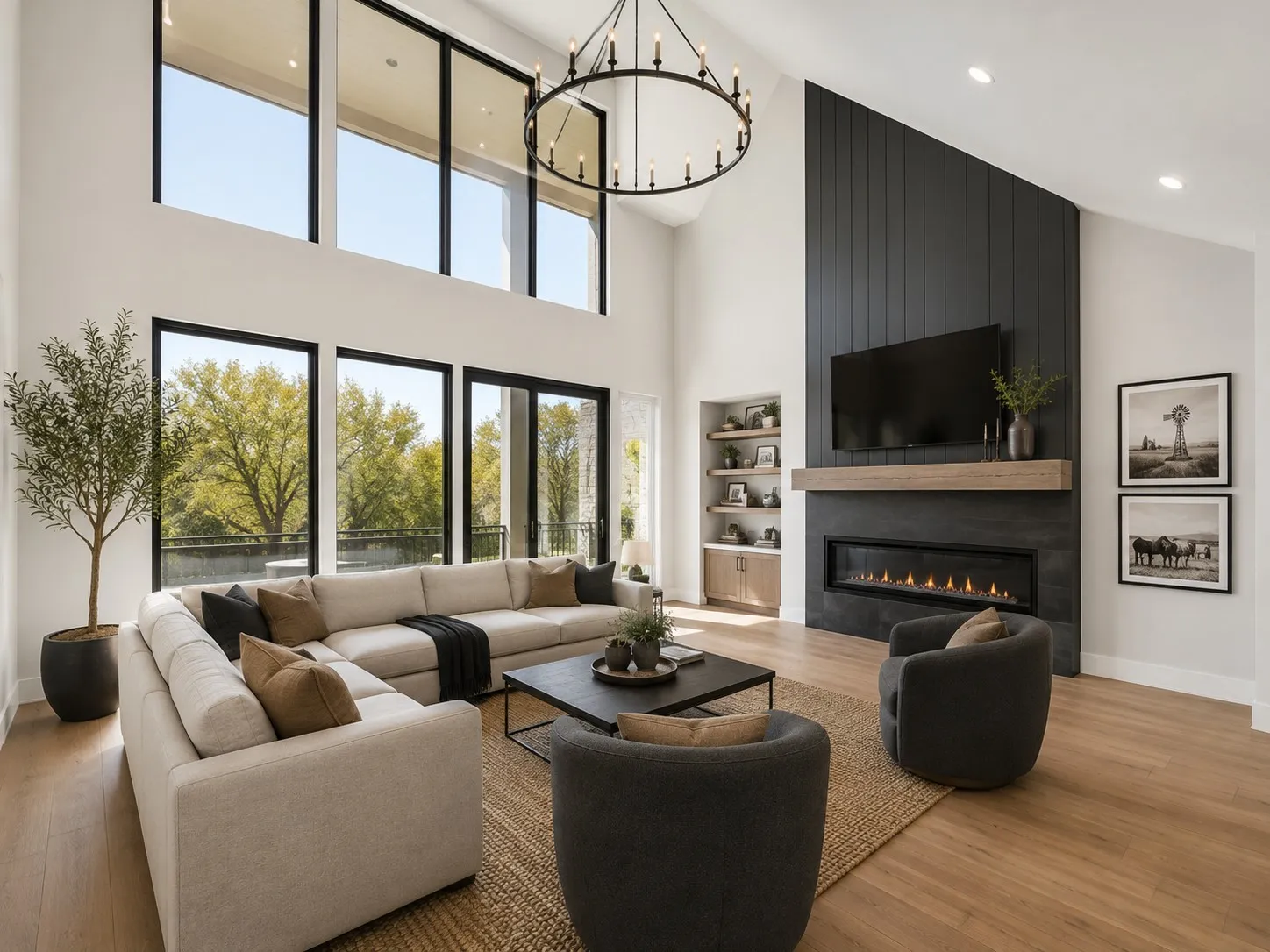 Vaulted ceilings, a linear fireplace with a wood mantle, wood-finish flooring, a built-in shelving unit, and large-format windows with dark trim