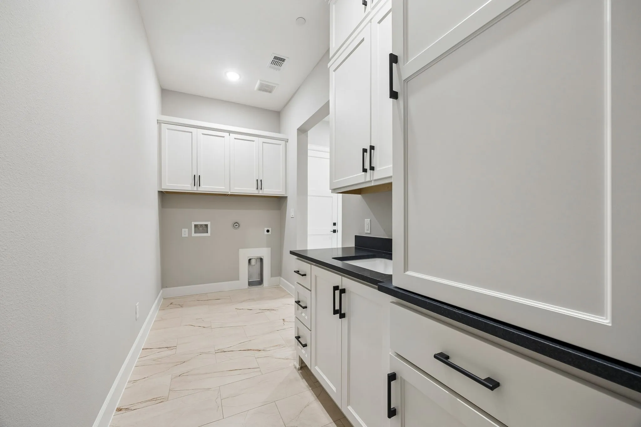 Laundry area featuring gas dryer hookup, light marble finish floors, cabinet space, hookup for an electric dryer, and washer hookup