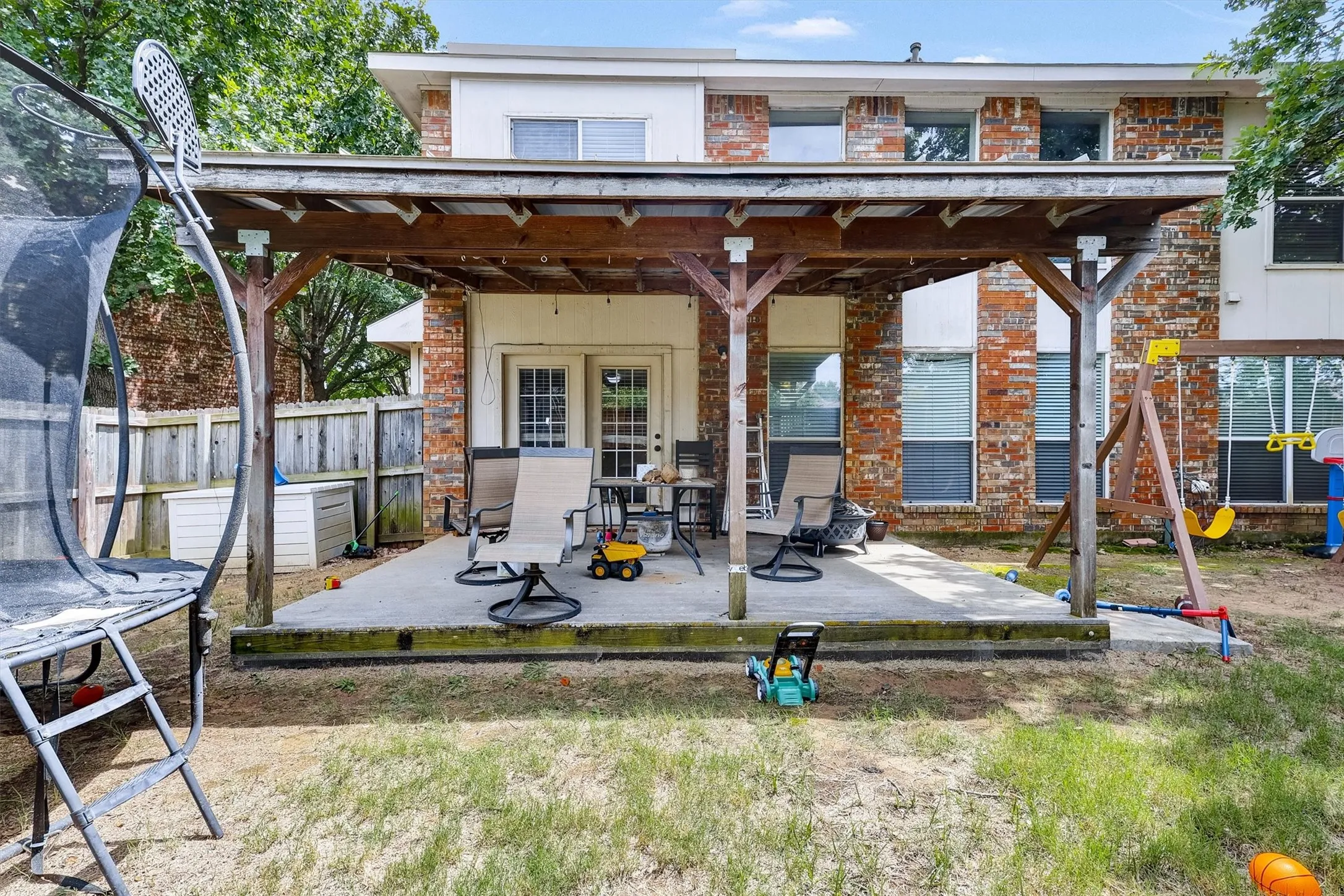 Rear view of property featuring a covered patio area