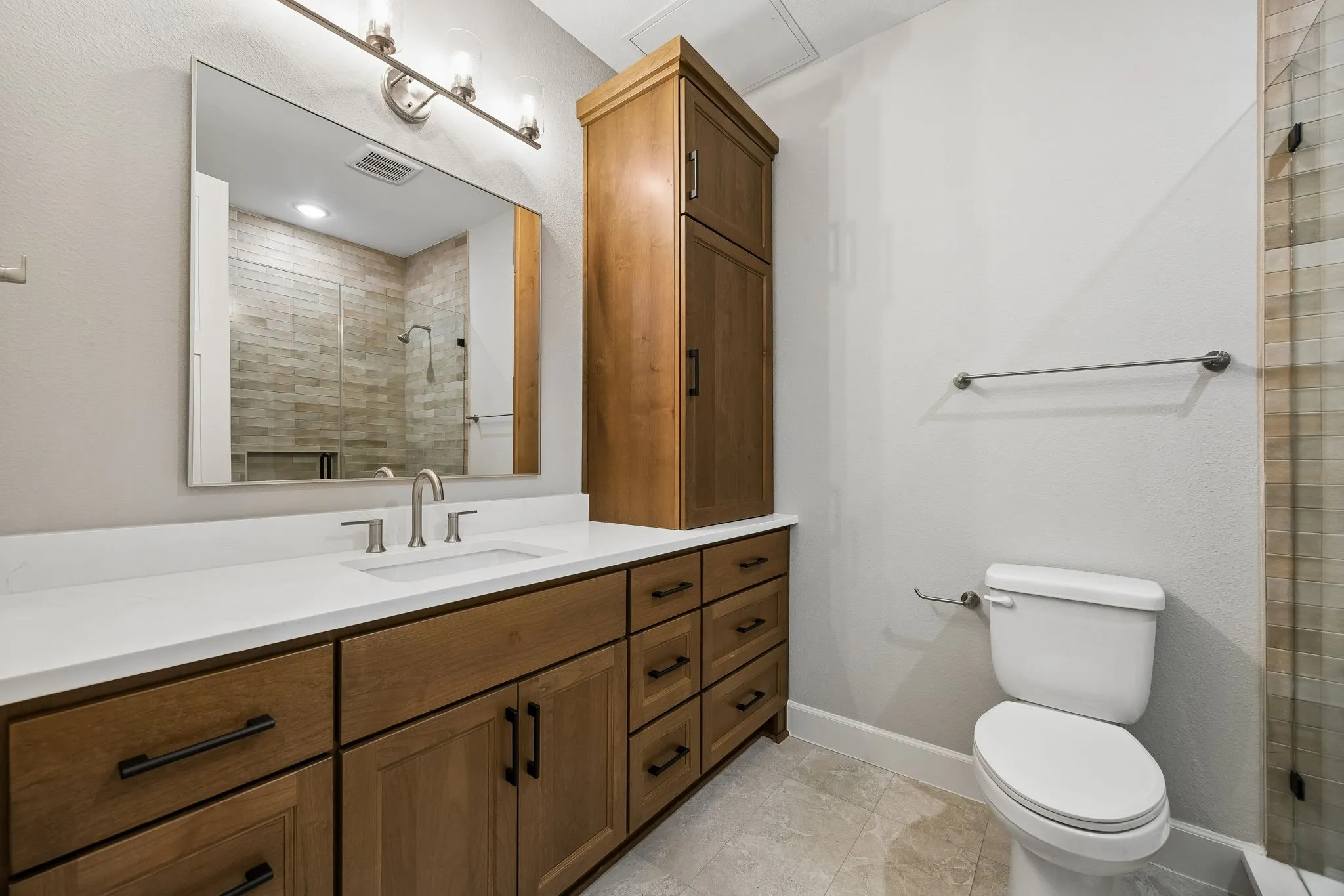 Full bathroom with vanity and a shower stall