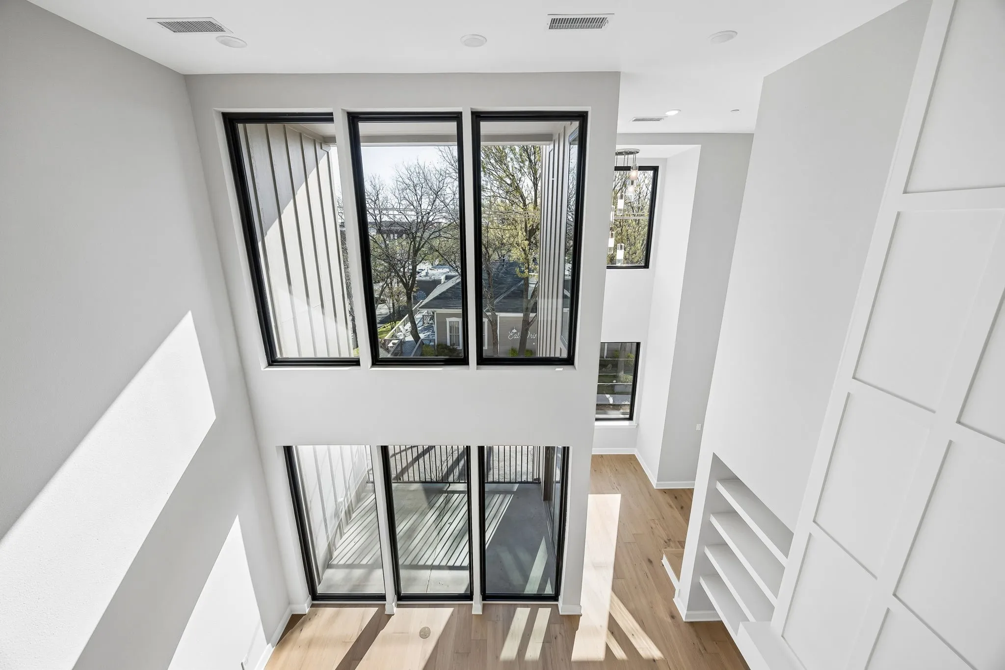 Stairway with wood finished floors and baseboards