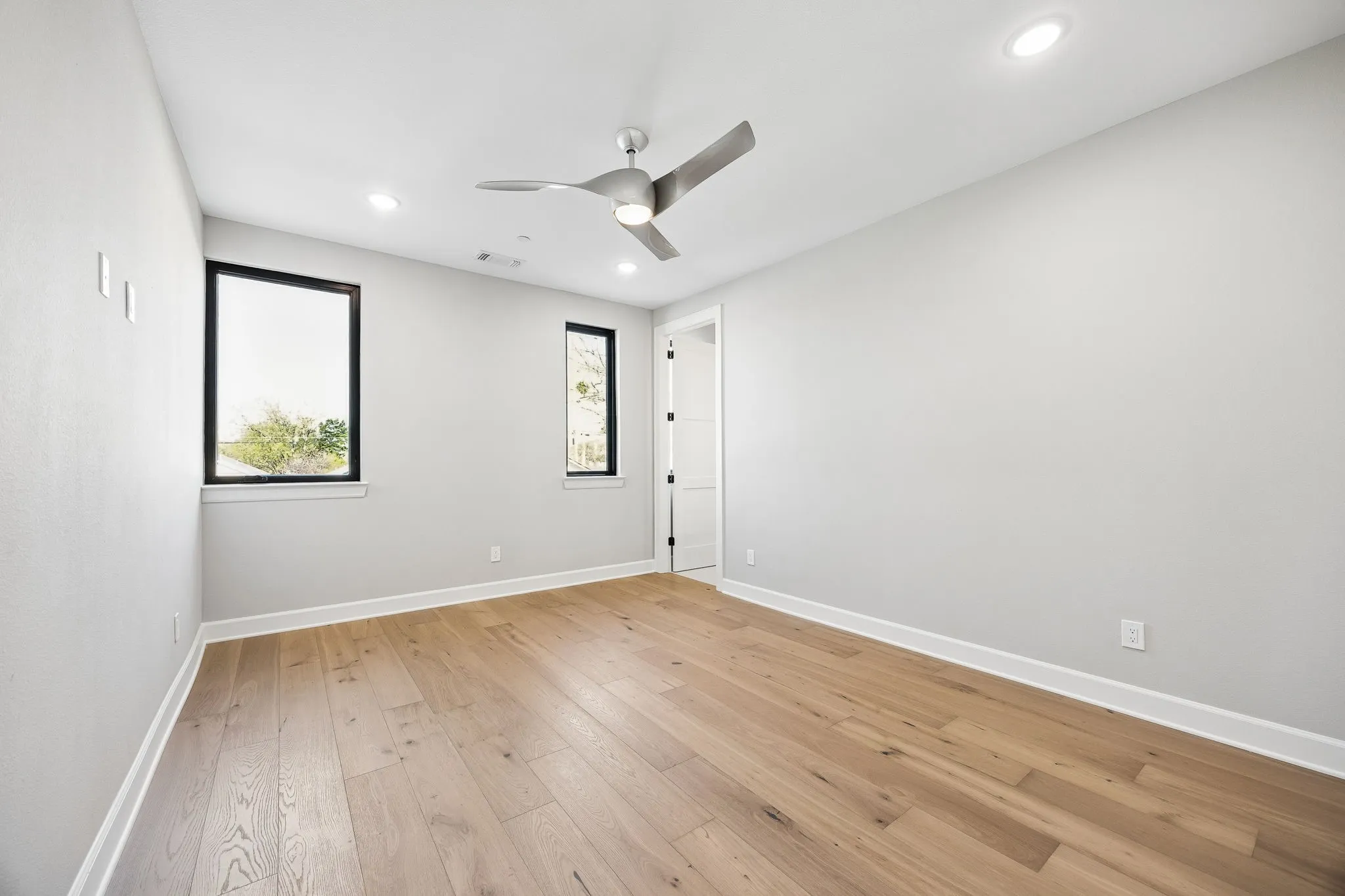 Spare room featuring a ceiling fan, light wood finished floors, and recessed lighting