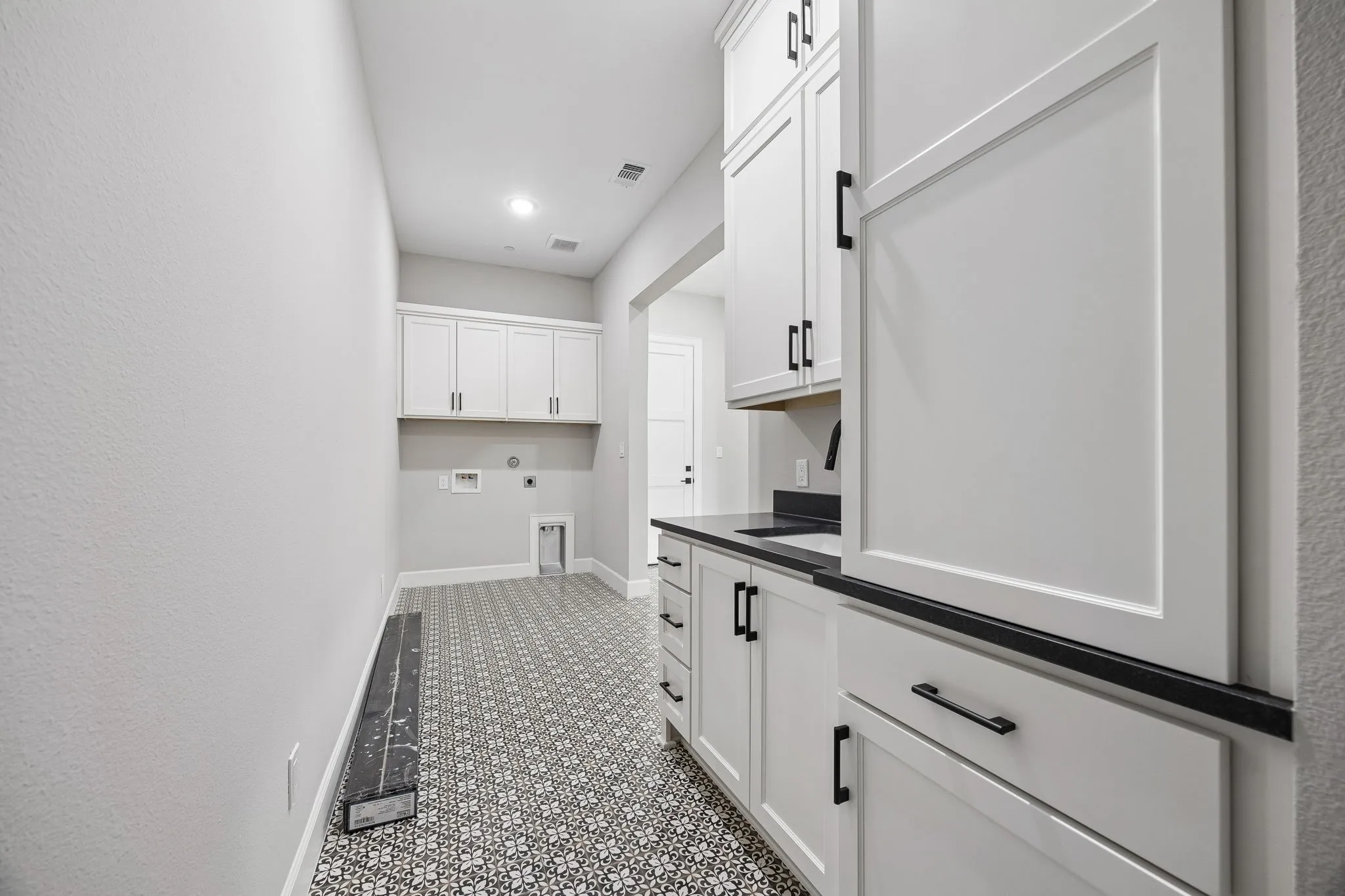 Laundry area with hookup for an electric dryer, washer hookup, cabinet space, and recessed lighting