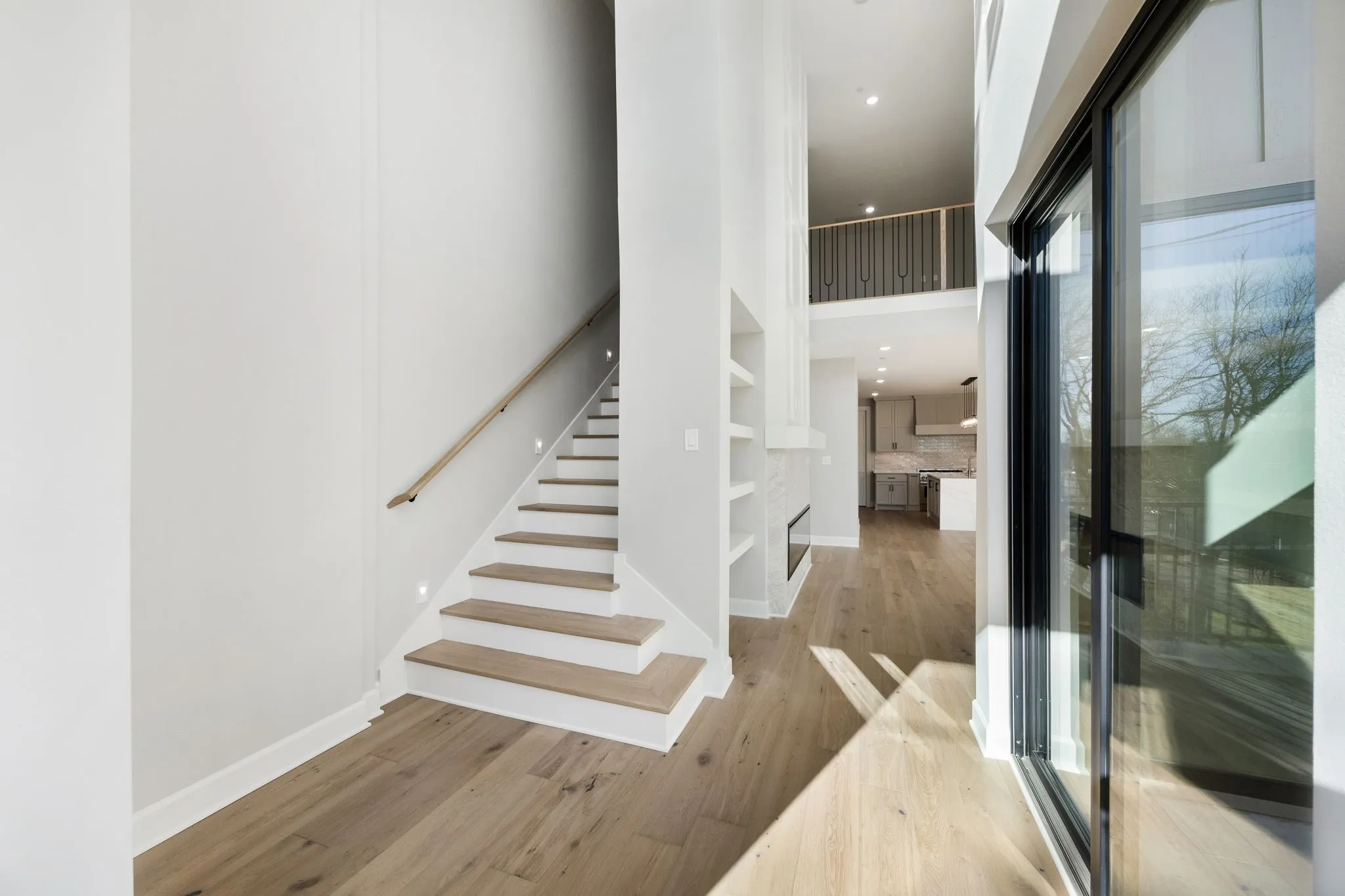 Staircase featuring wood finished floors and a high ceiling
