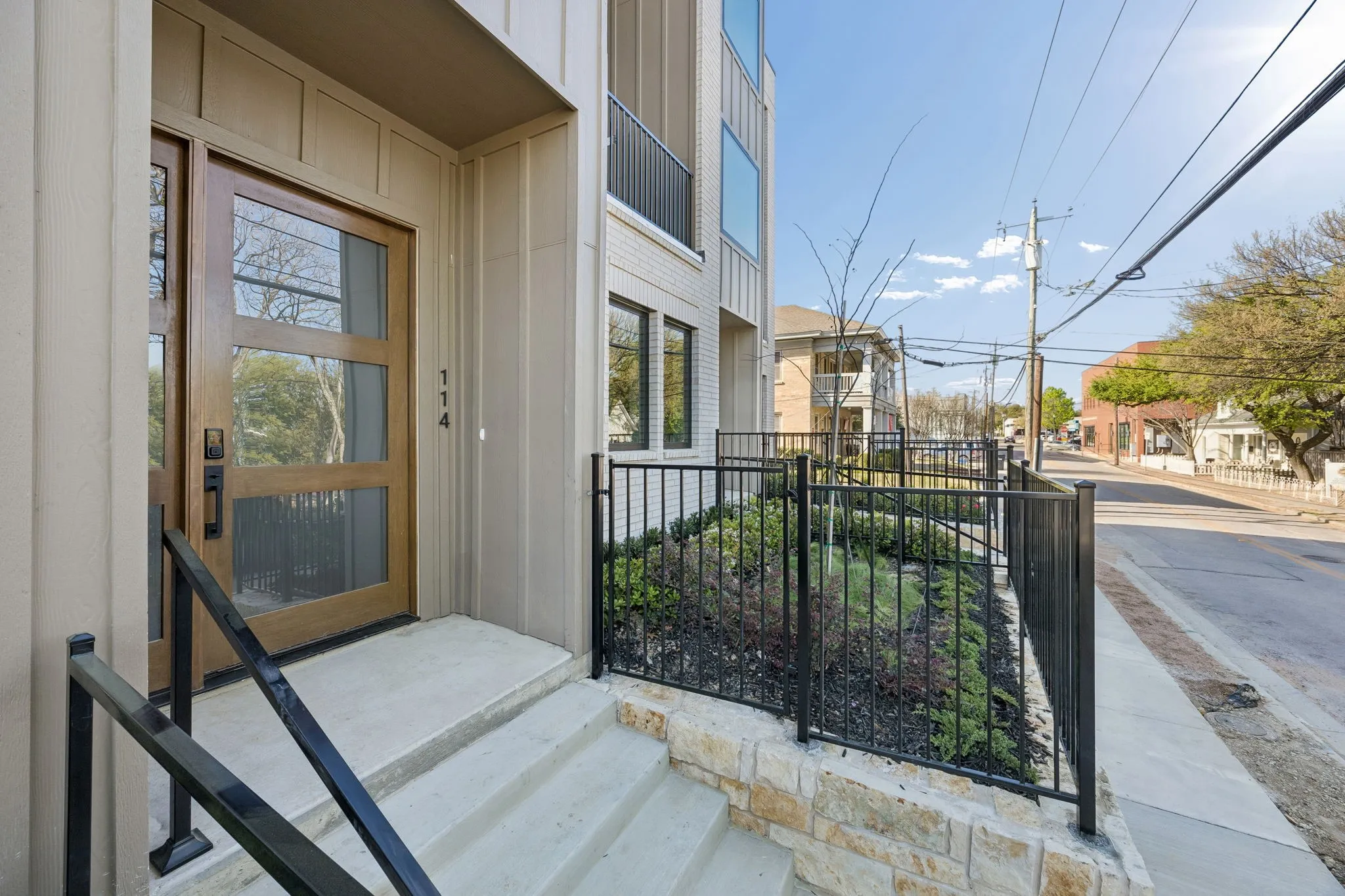 View of exterior entry with a residential view and board and batten siding