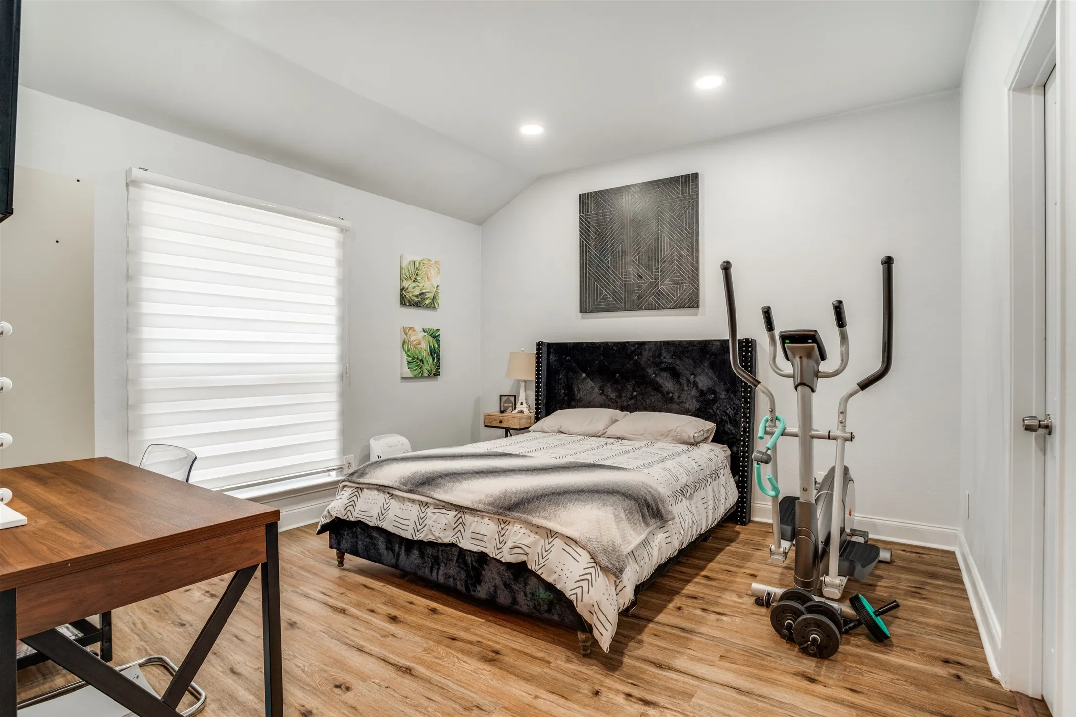 Bedroom with light wood-type flooring, vaulted ceiling, and recessed lighting