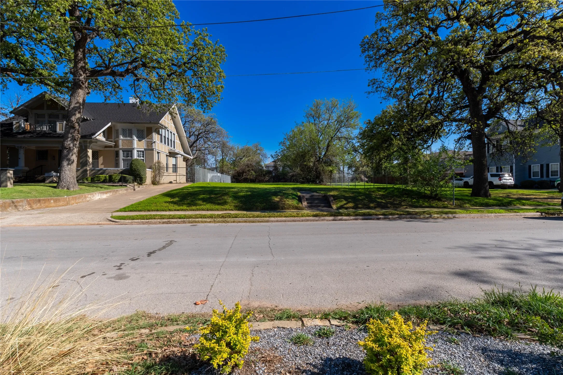 View of asphalt street featuring sidewalks and curbs