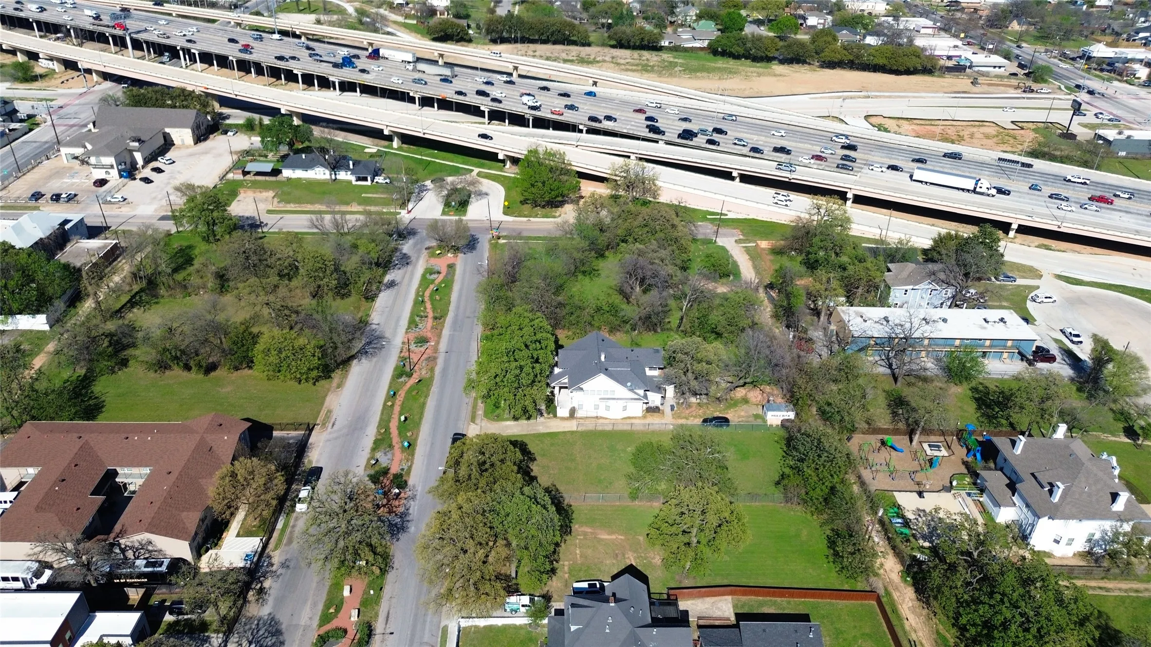 Aerial view of property's location with a highway and nearby suburban area