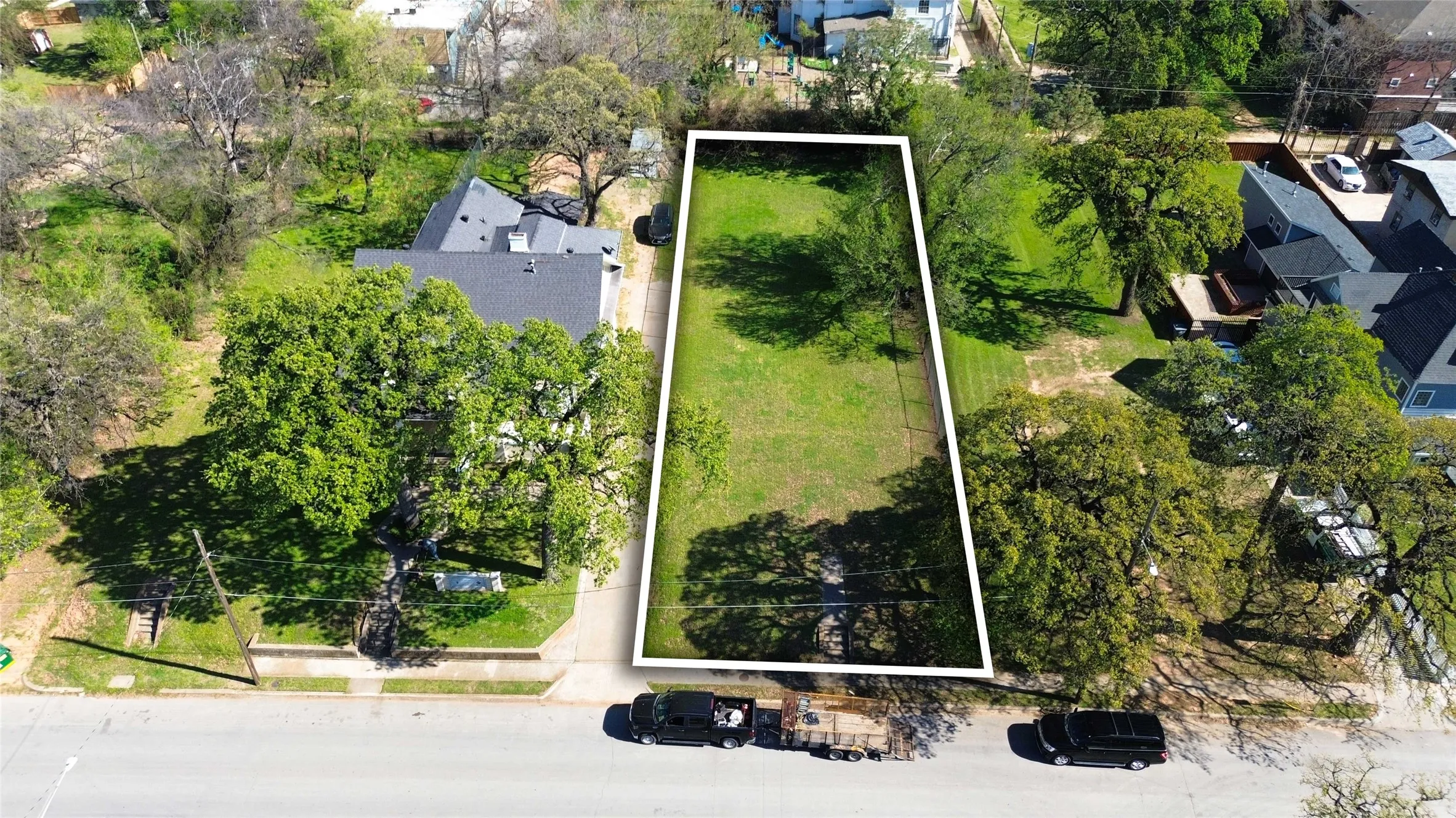 Aerial view of property and surrounding area with property parcel outlined