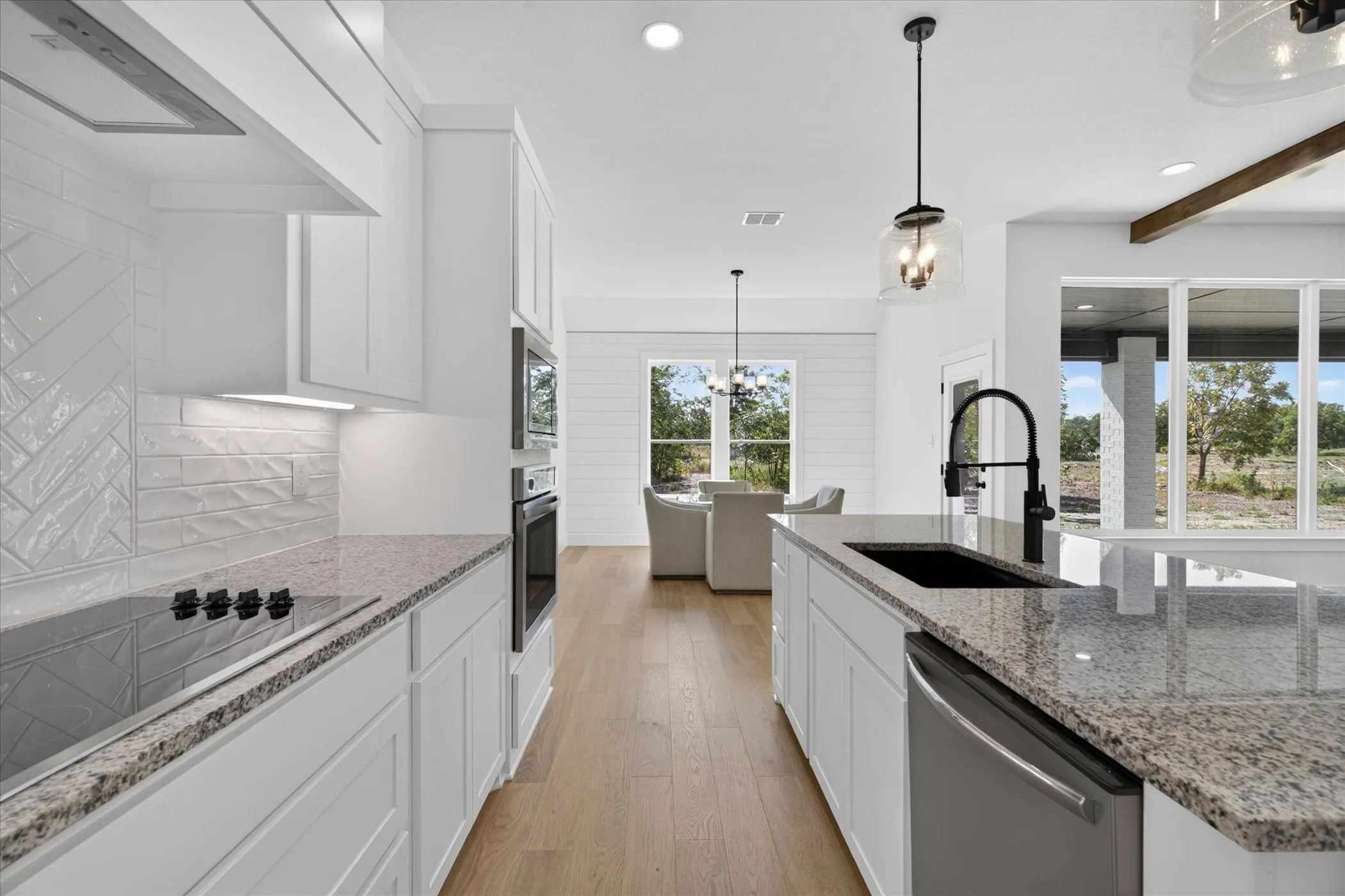 Kitchen featuring granite countertops, a built-in oven, and a cooktop