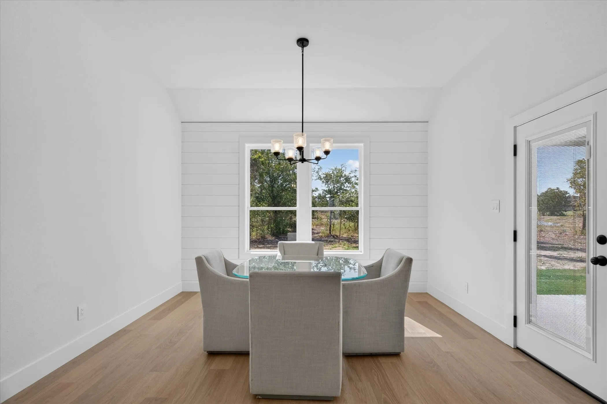 Wood-finish flooring with white baseboards