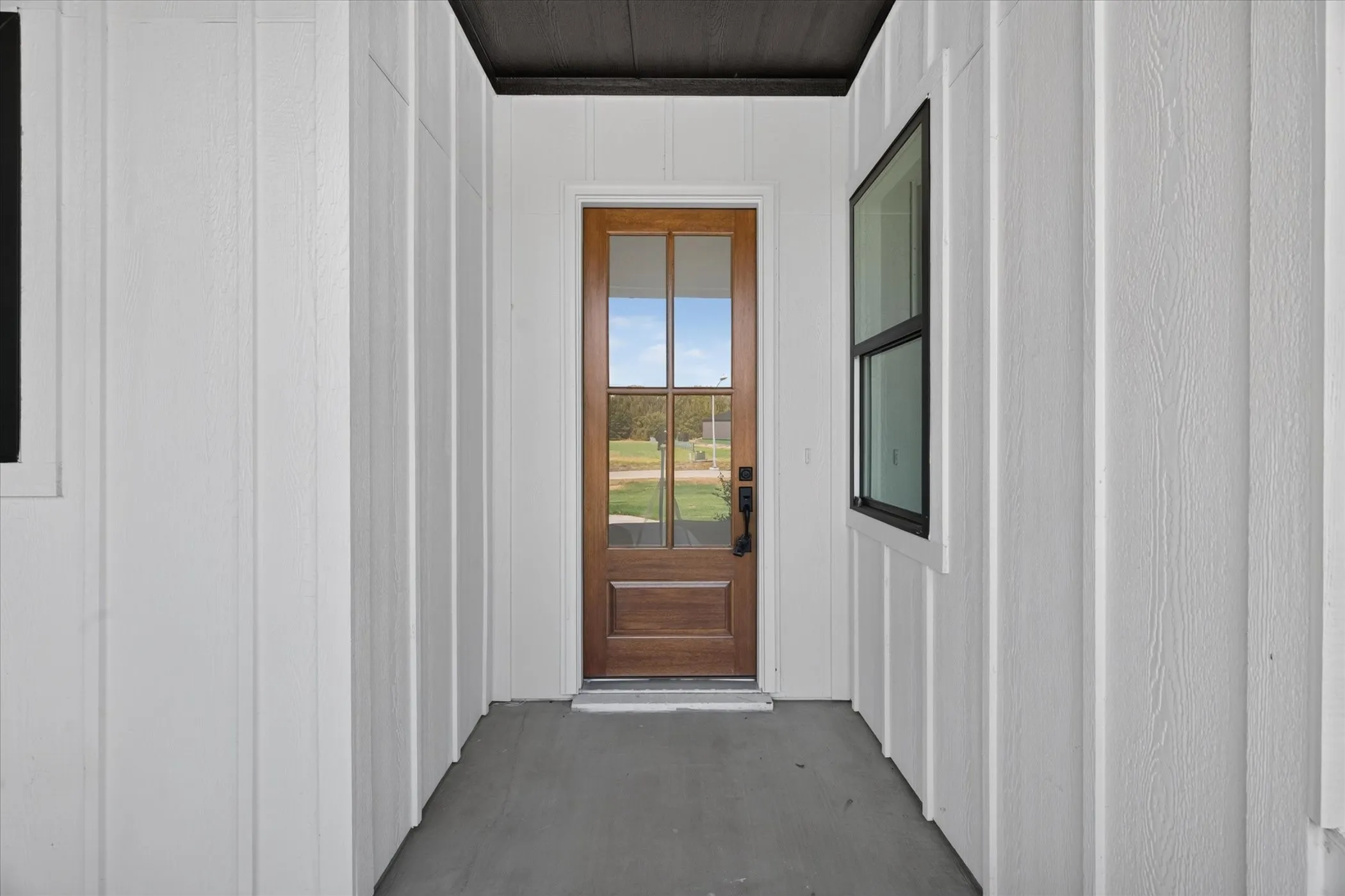 Wood-paneled entry door with glass inserts