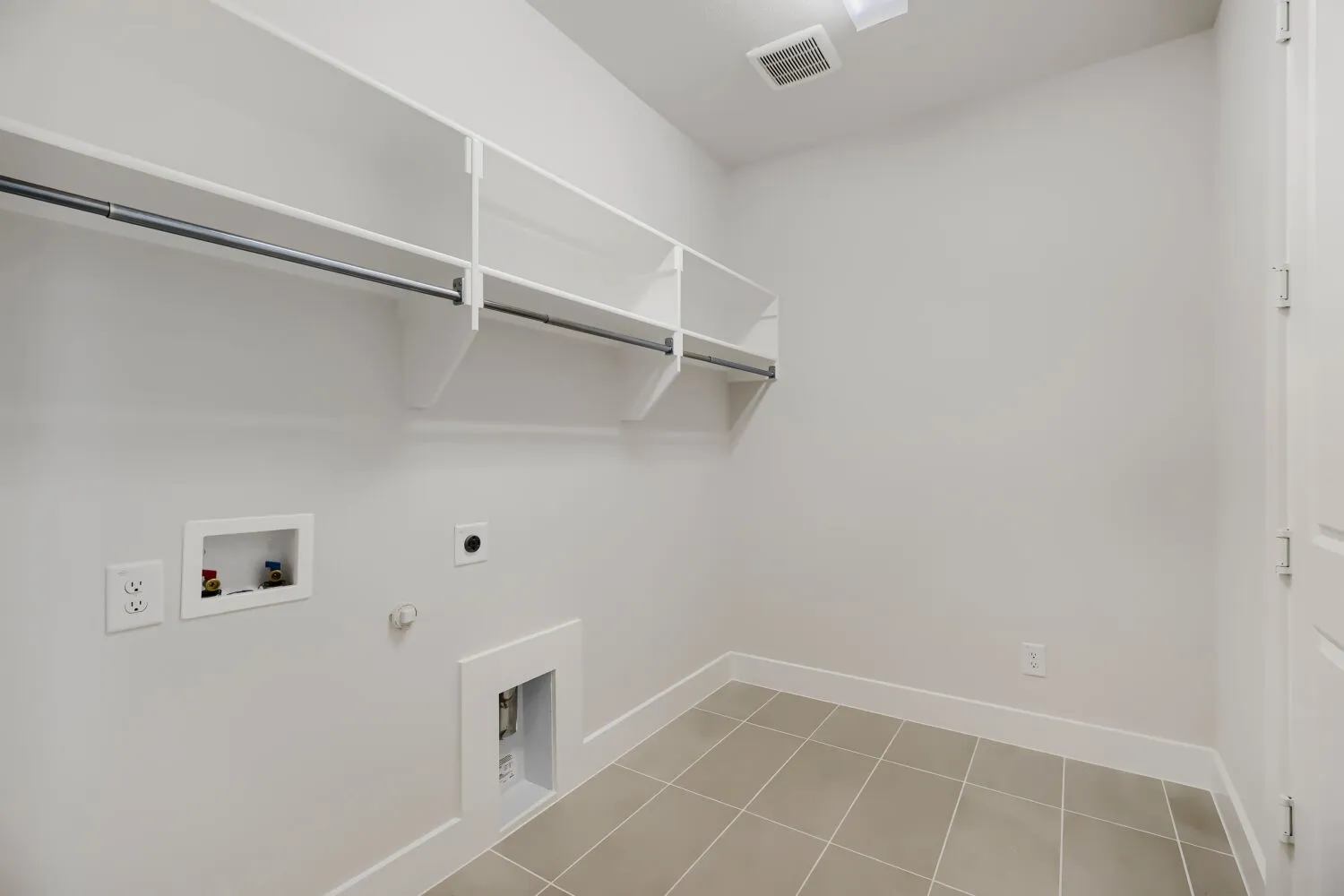 Utility room with integrated storage shelving and hanging rod