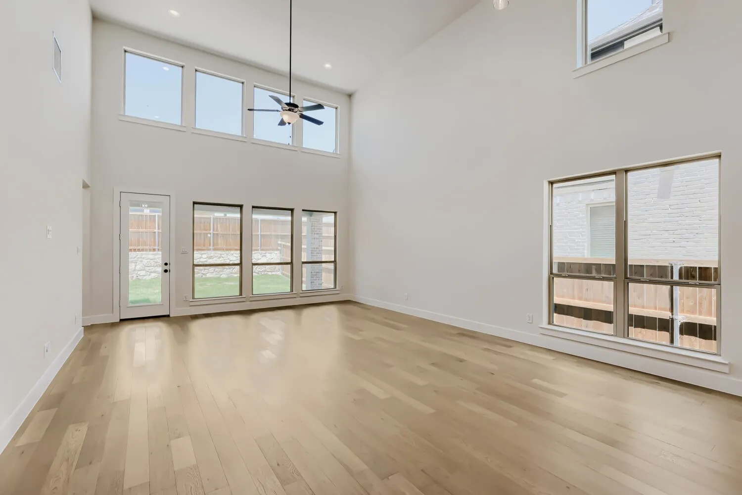 Vaulted ceilings showcasing a contemporary ceiling fan and recessed lighting