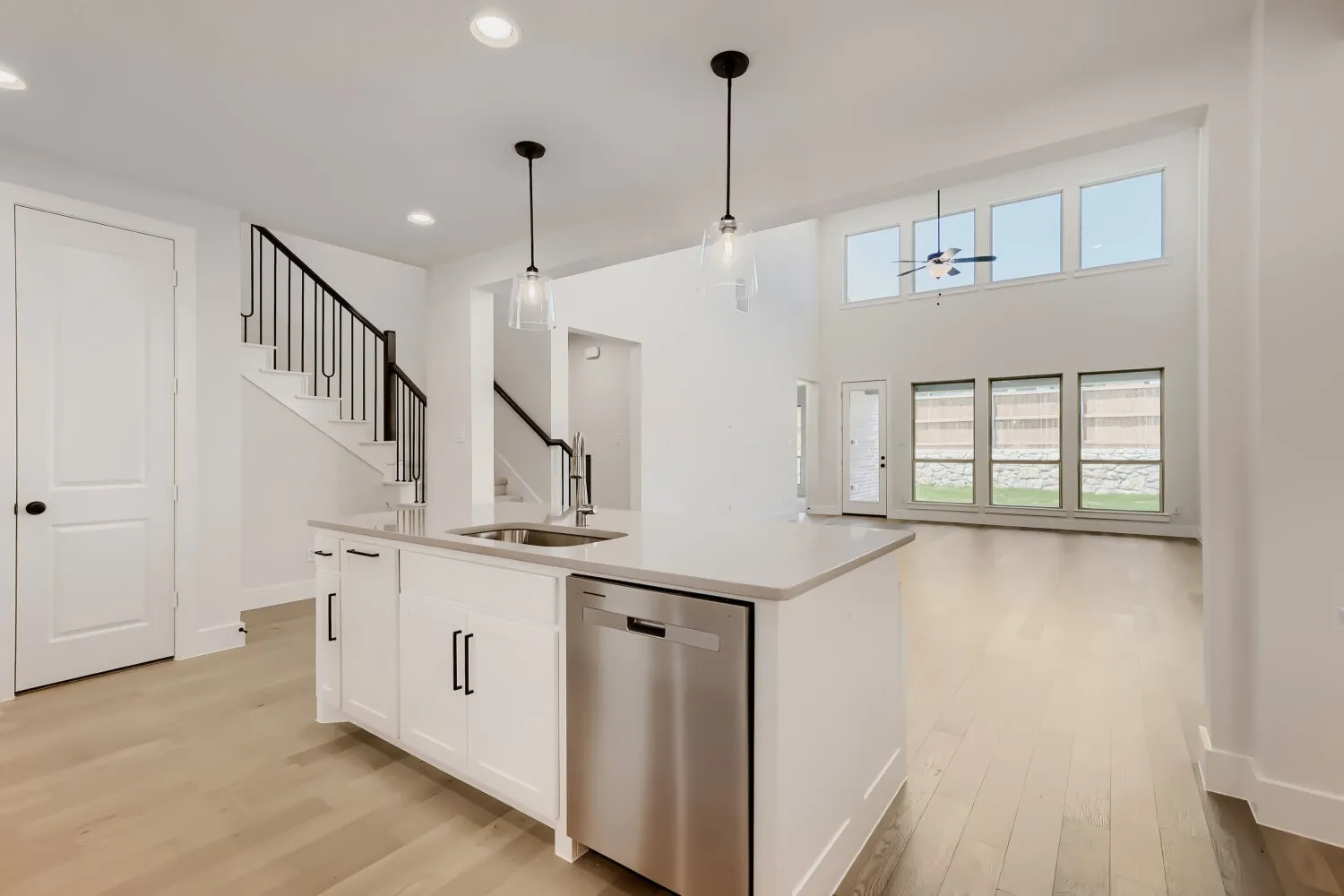 Kitchen island with a stainless steel dishwasher and undermount sink