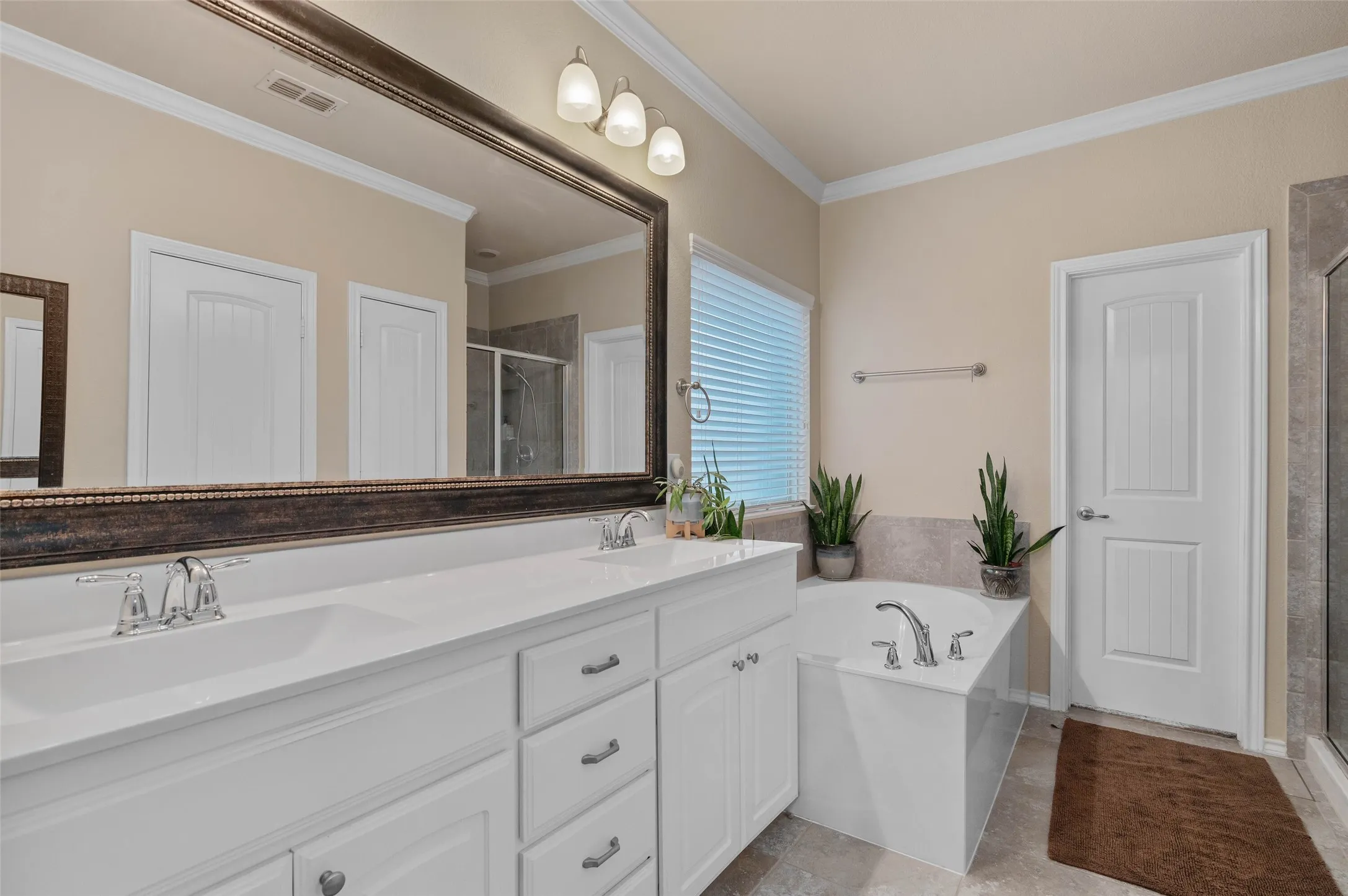 Dual sinks, garden tub and separate shower in primary bathroom