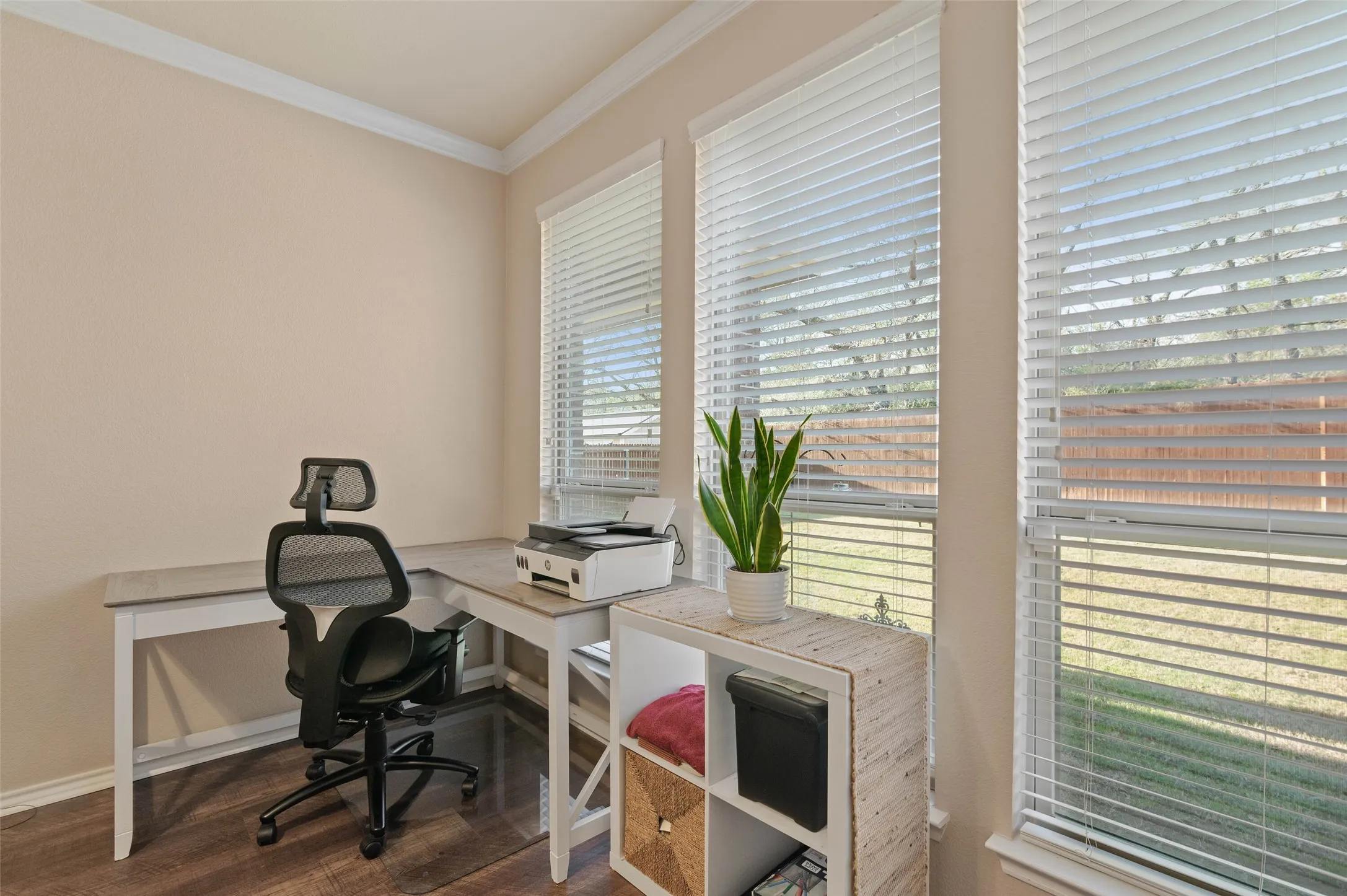 Views out to the private backyard area from the primary bedroom windows with room for an office nook.