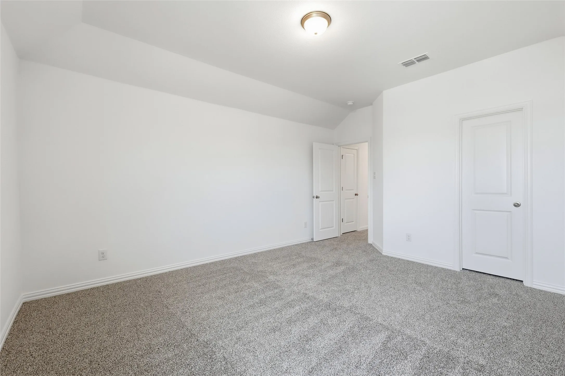 Room featuring neutral-toned carpet, white walls, and white baseboards