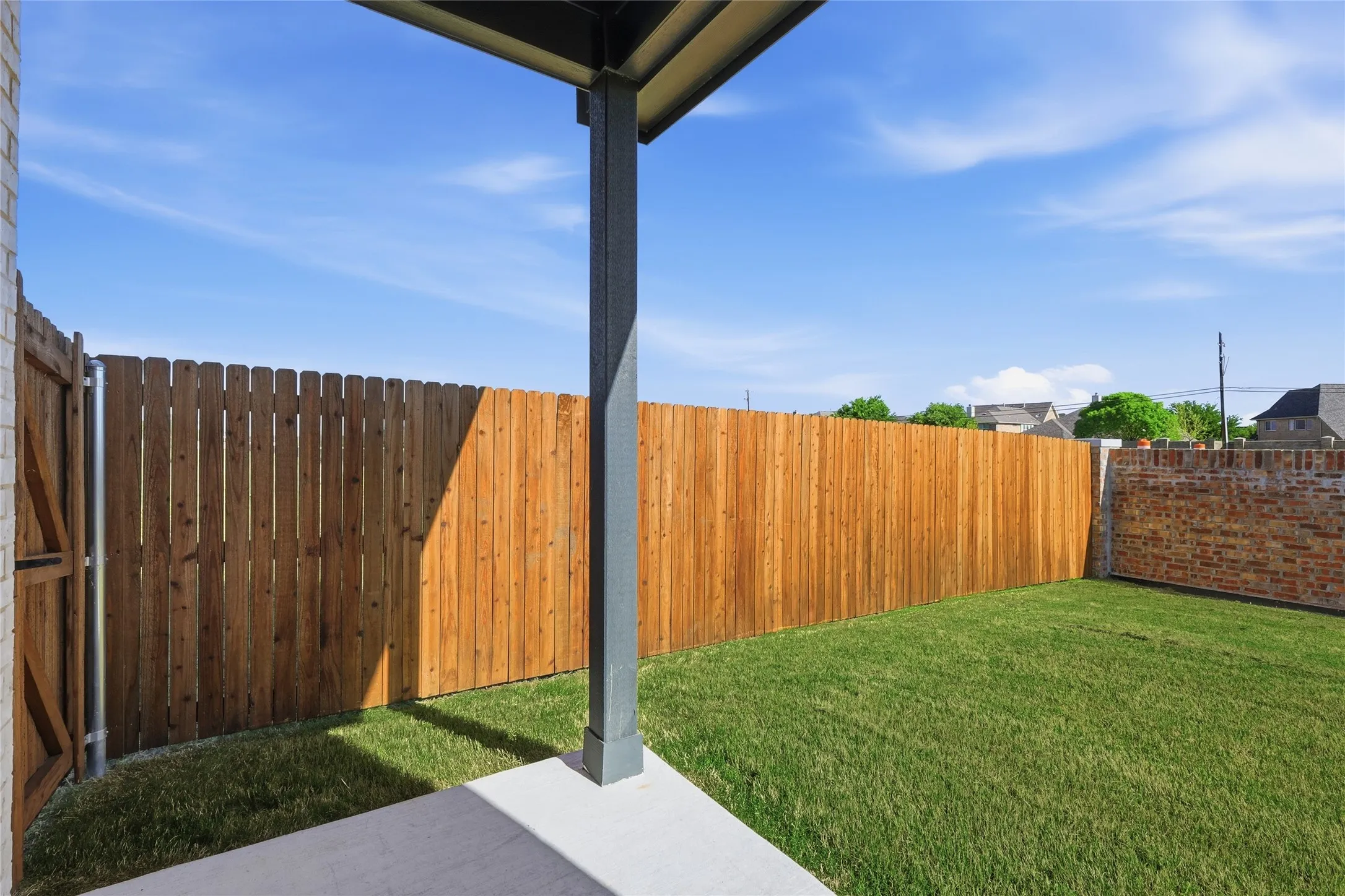 Fenced backyard featuring a patio