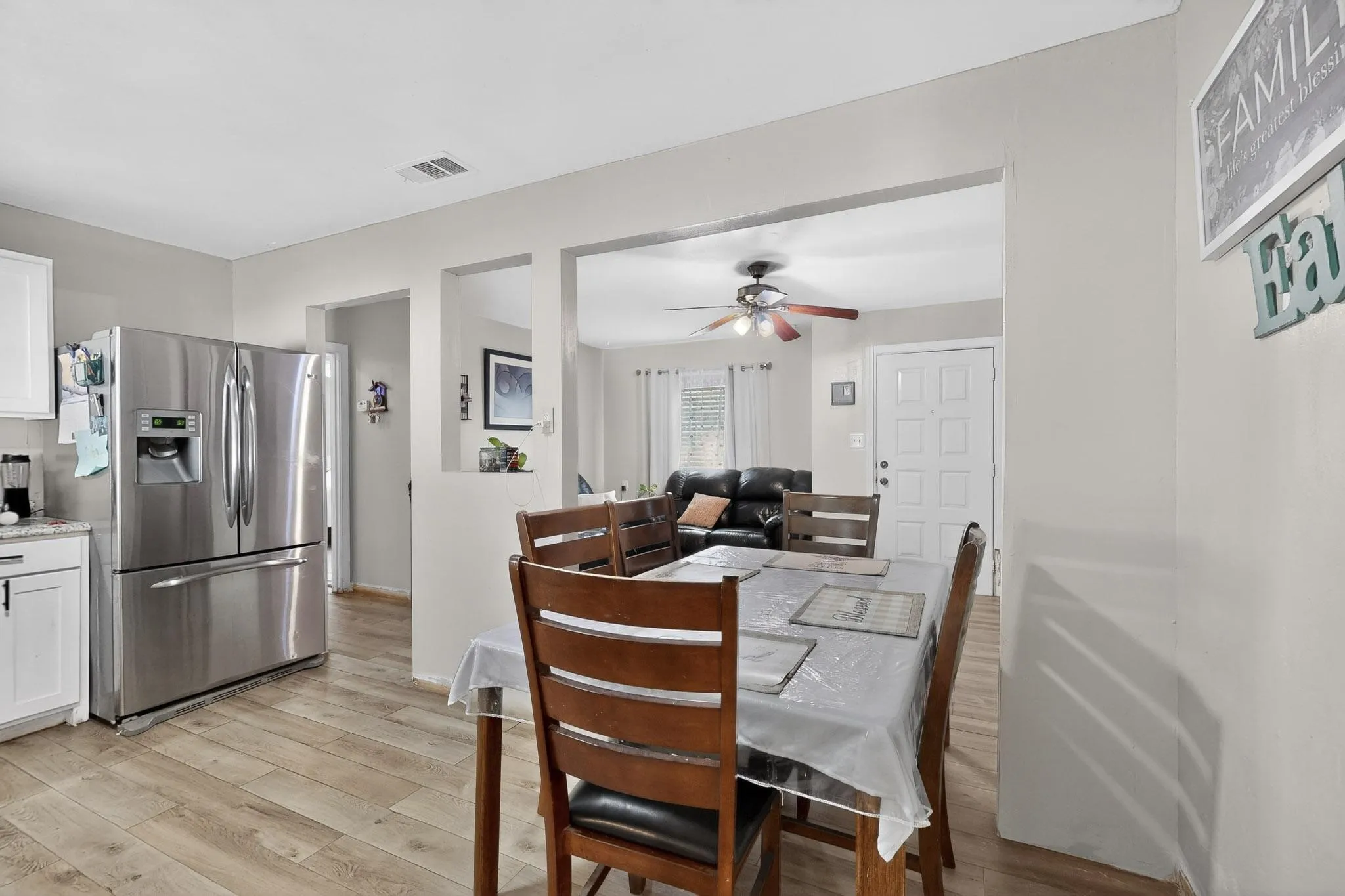 Dining area with light wood-style flooring and ceiling fan