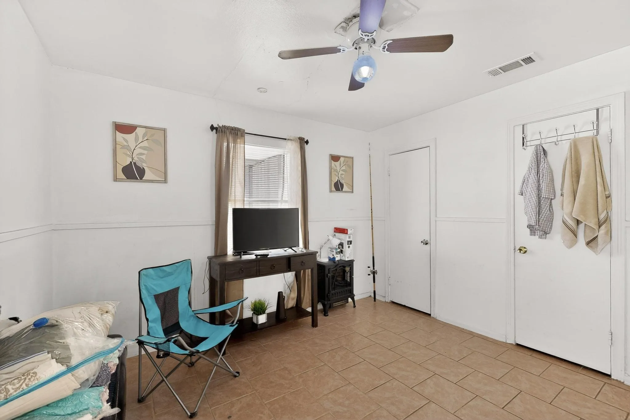 Office with ceiling fan and light tile patterned floors