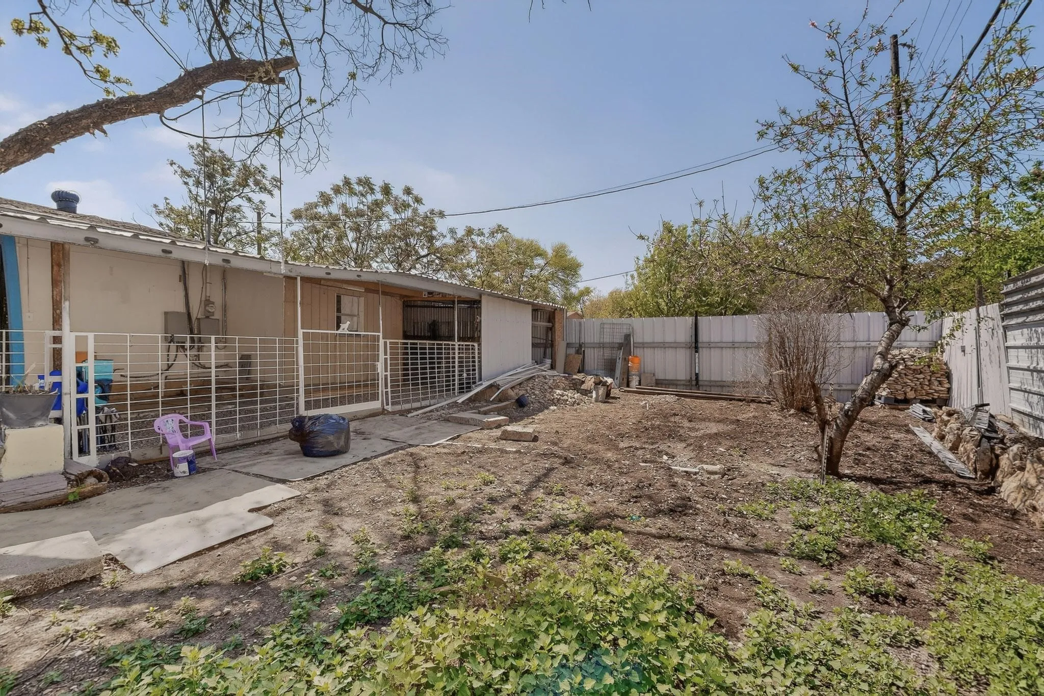 Rear view of house featuring an outdoor structure and a fenced backyard