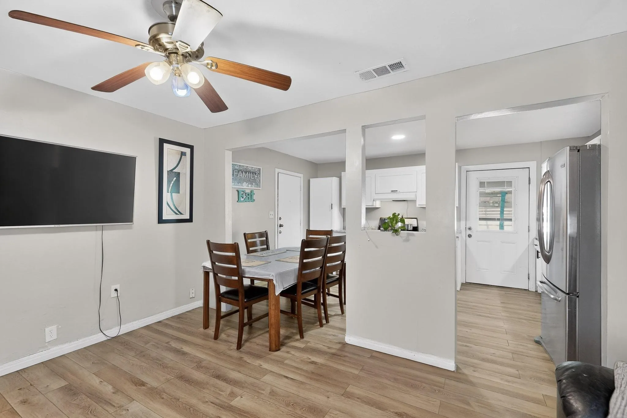 Dining area with light wood-style flooring and a ceiling fan