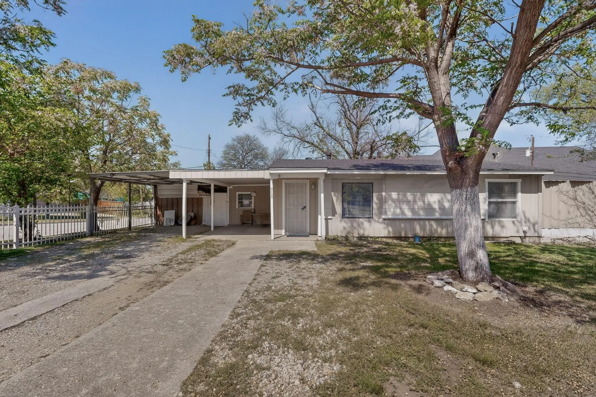 Single story home with a carport and driveway