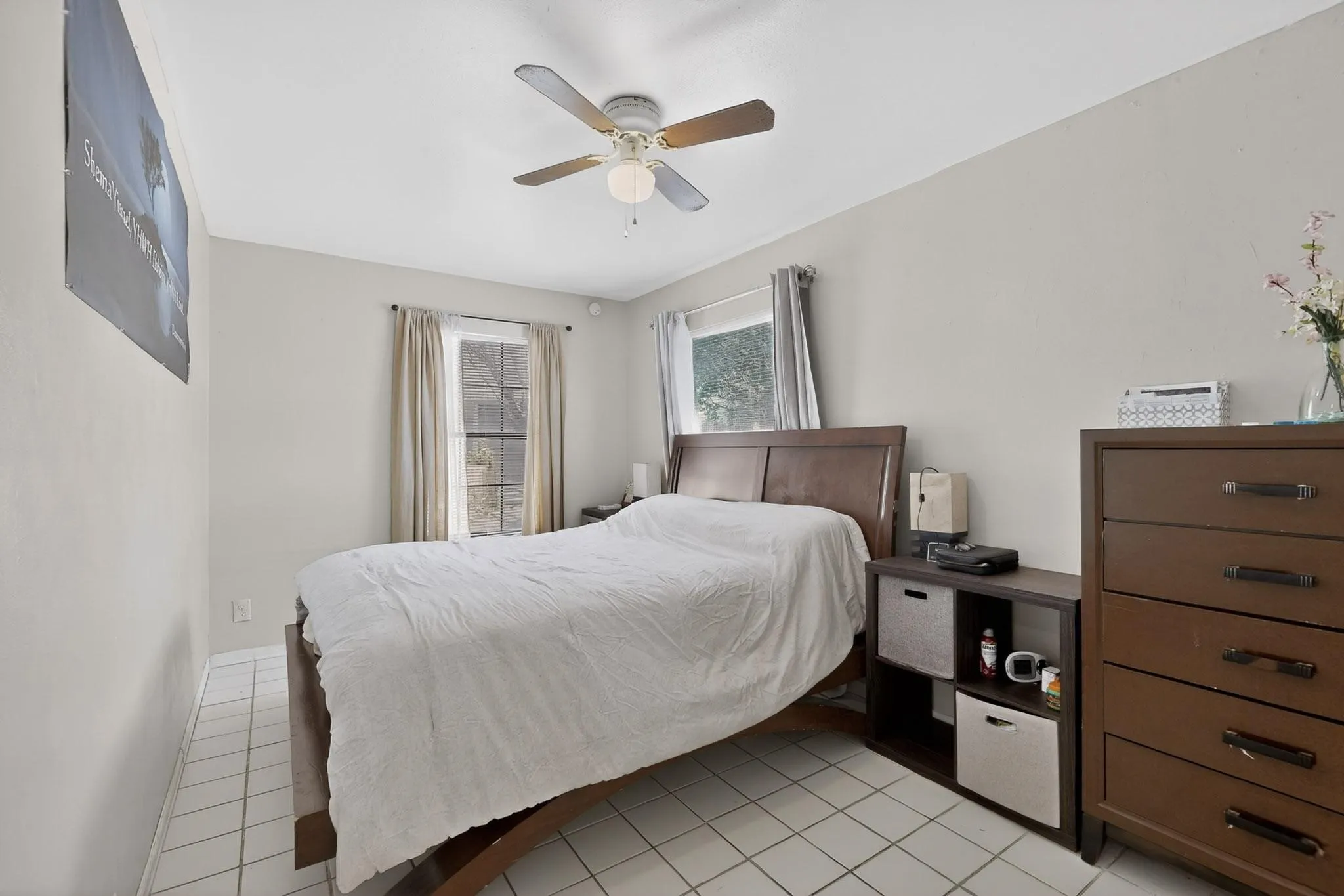 Bedroom featuring light tile patterned flooring and a ceiling fan
