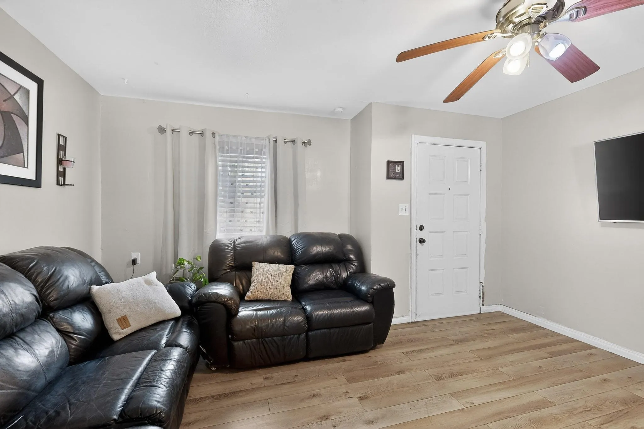 Living room featuring light wood finished floors and ceiling fan