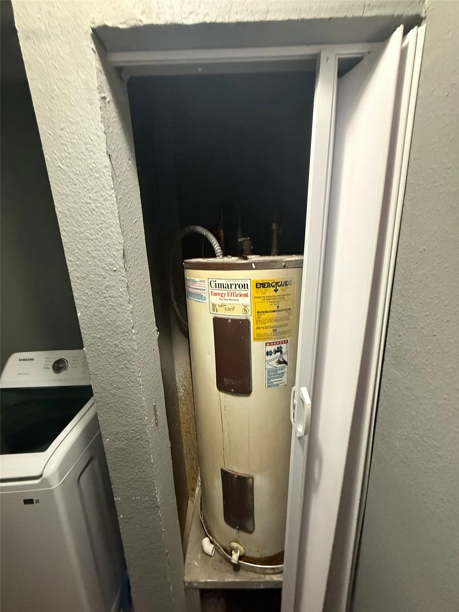 Utilities featuring washer / clothes dryer and electric water heater
