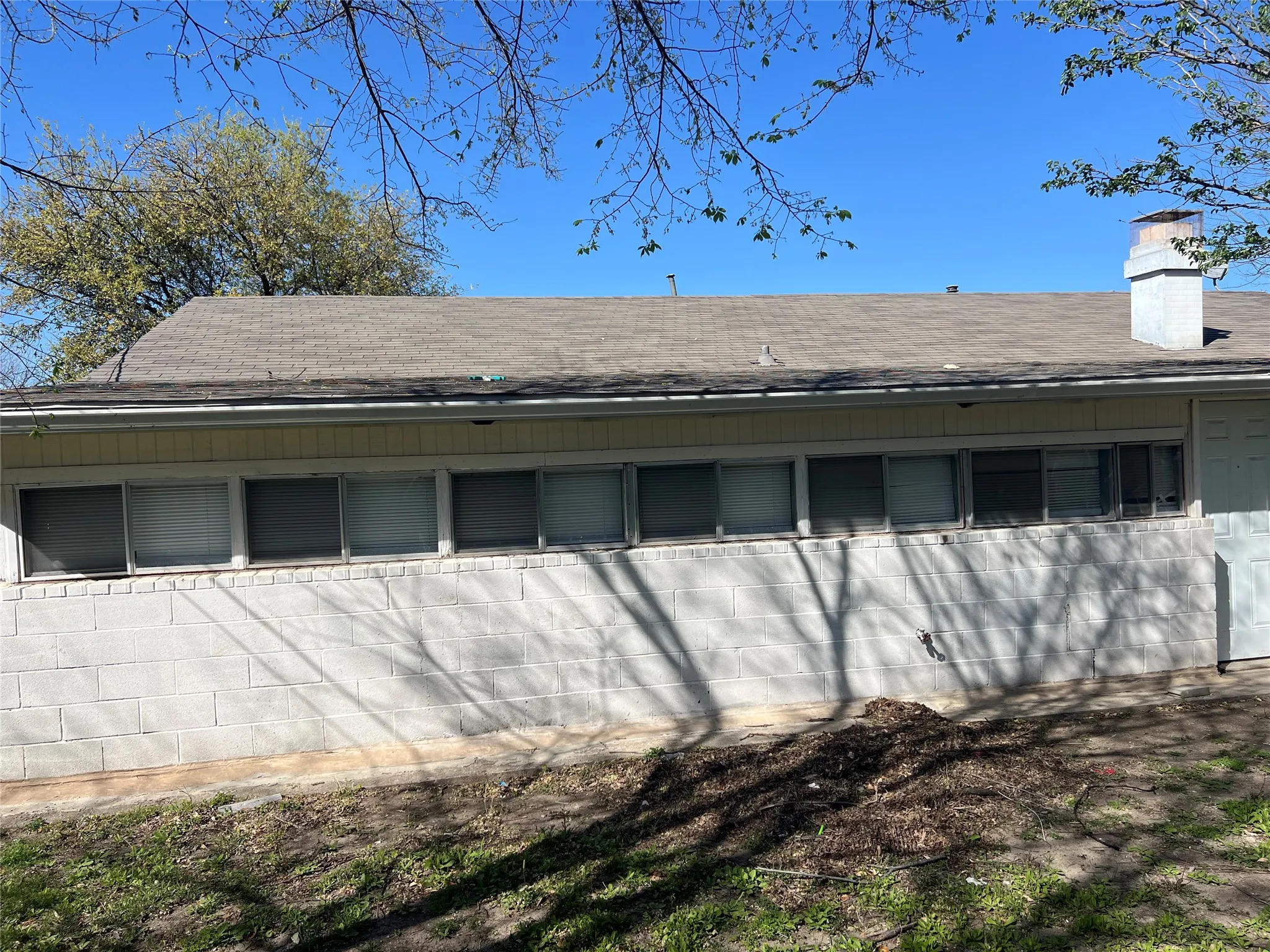 Exterior view of a chimney and concrete block siding