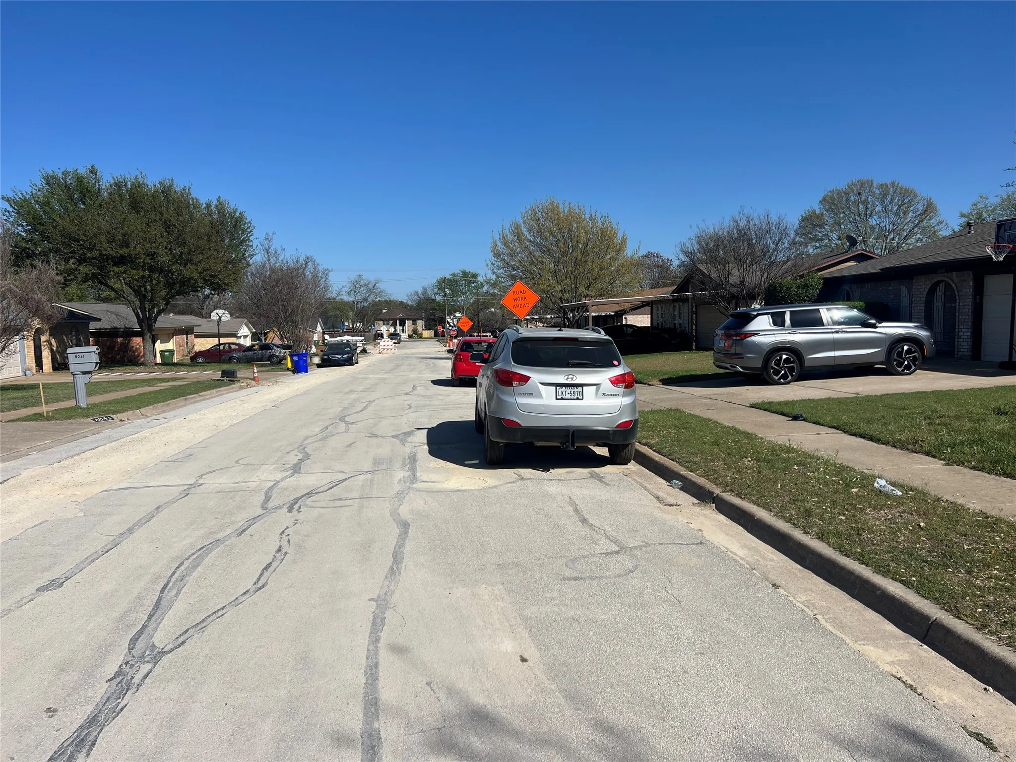 View of asphalt road with sidewalks, curbs, and a residential view