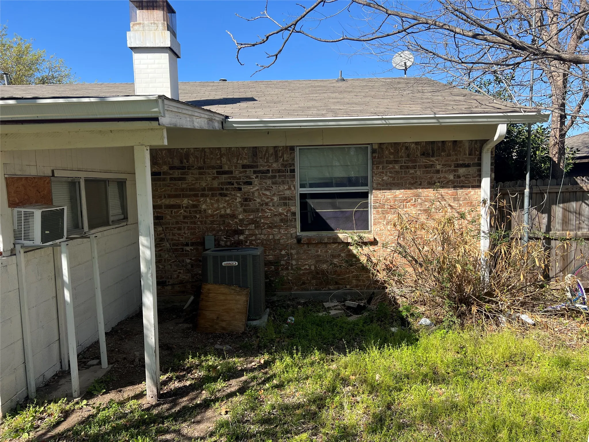 View of property exterior featuring a chimney, roof with shingles, and cooling unit