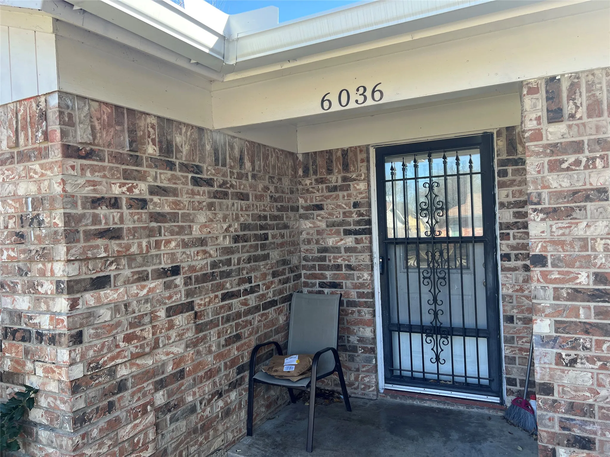 Doorway to property with brick siding