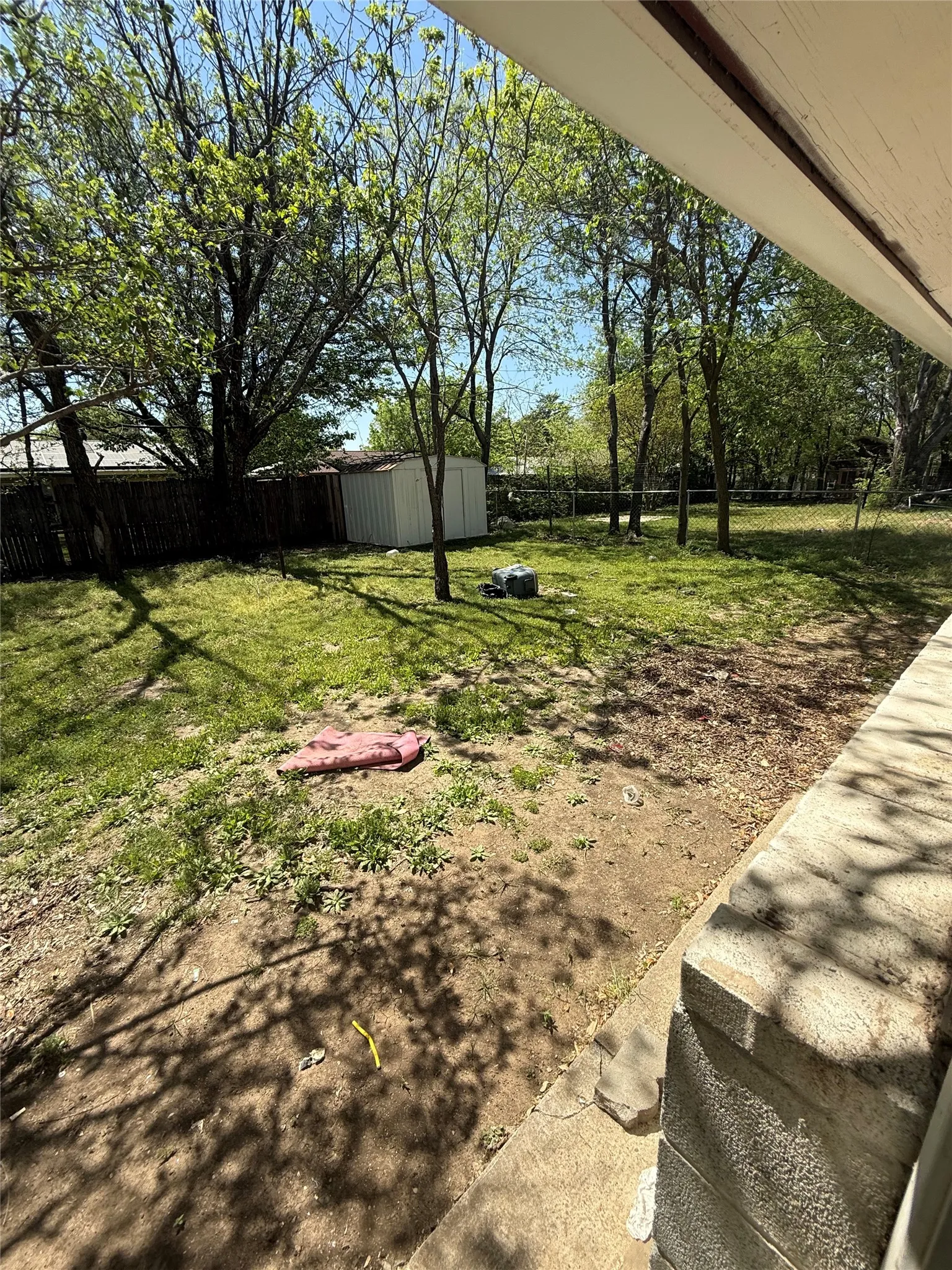 Fenced backyard with a shed